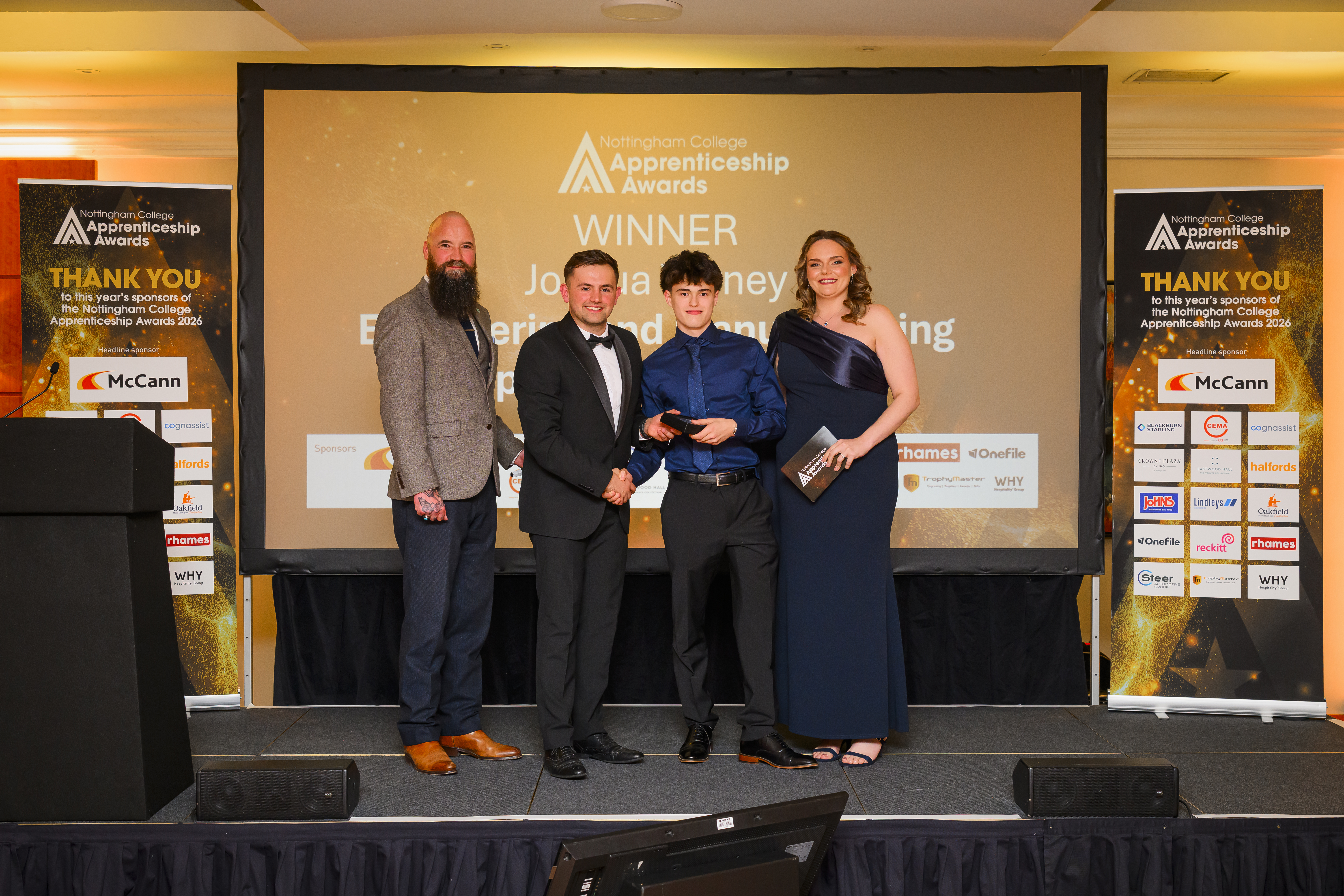 Josh Vearny on stage receiving his award