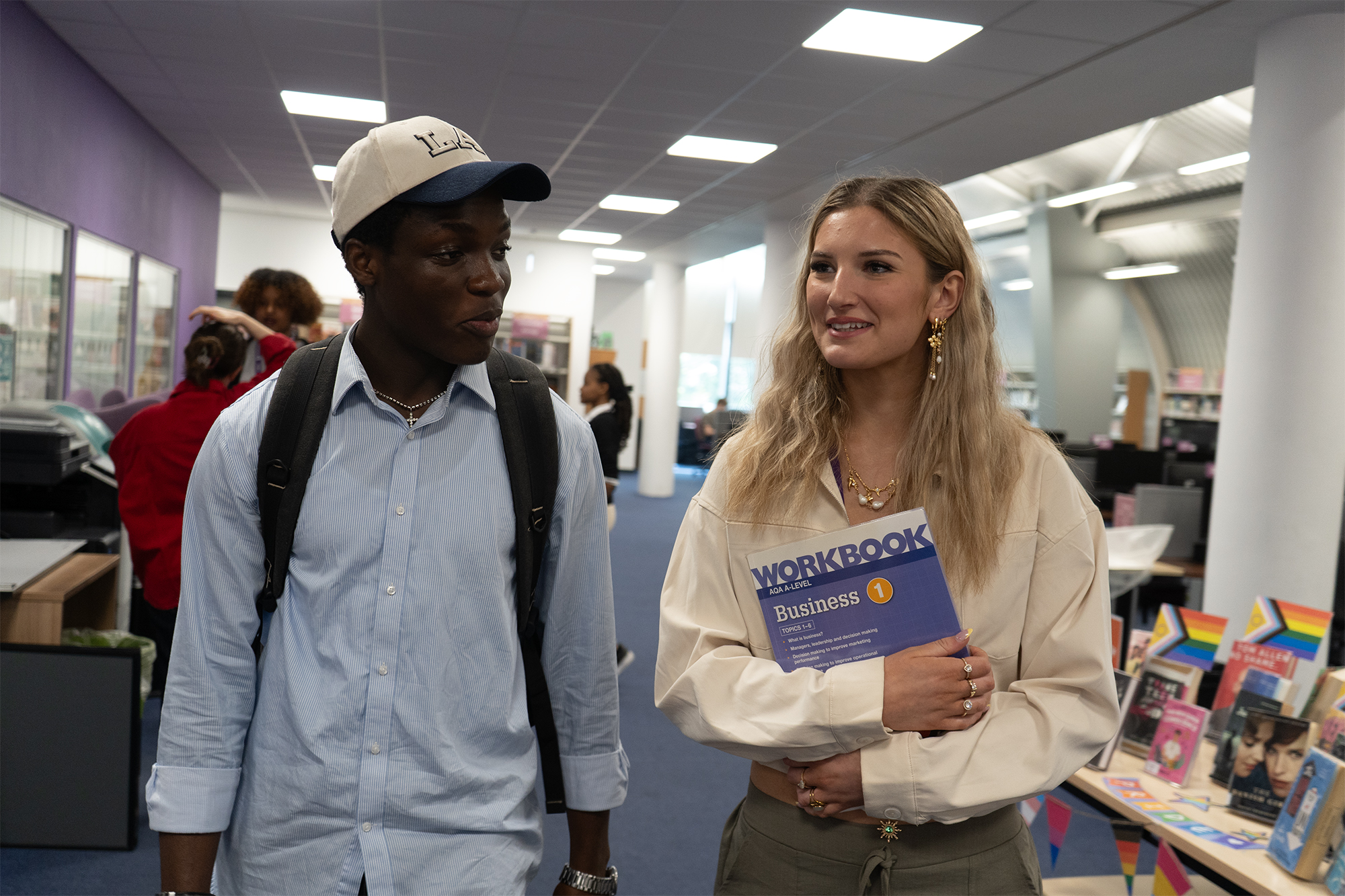 Two students walking down a corridor