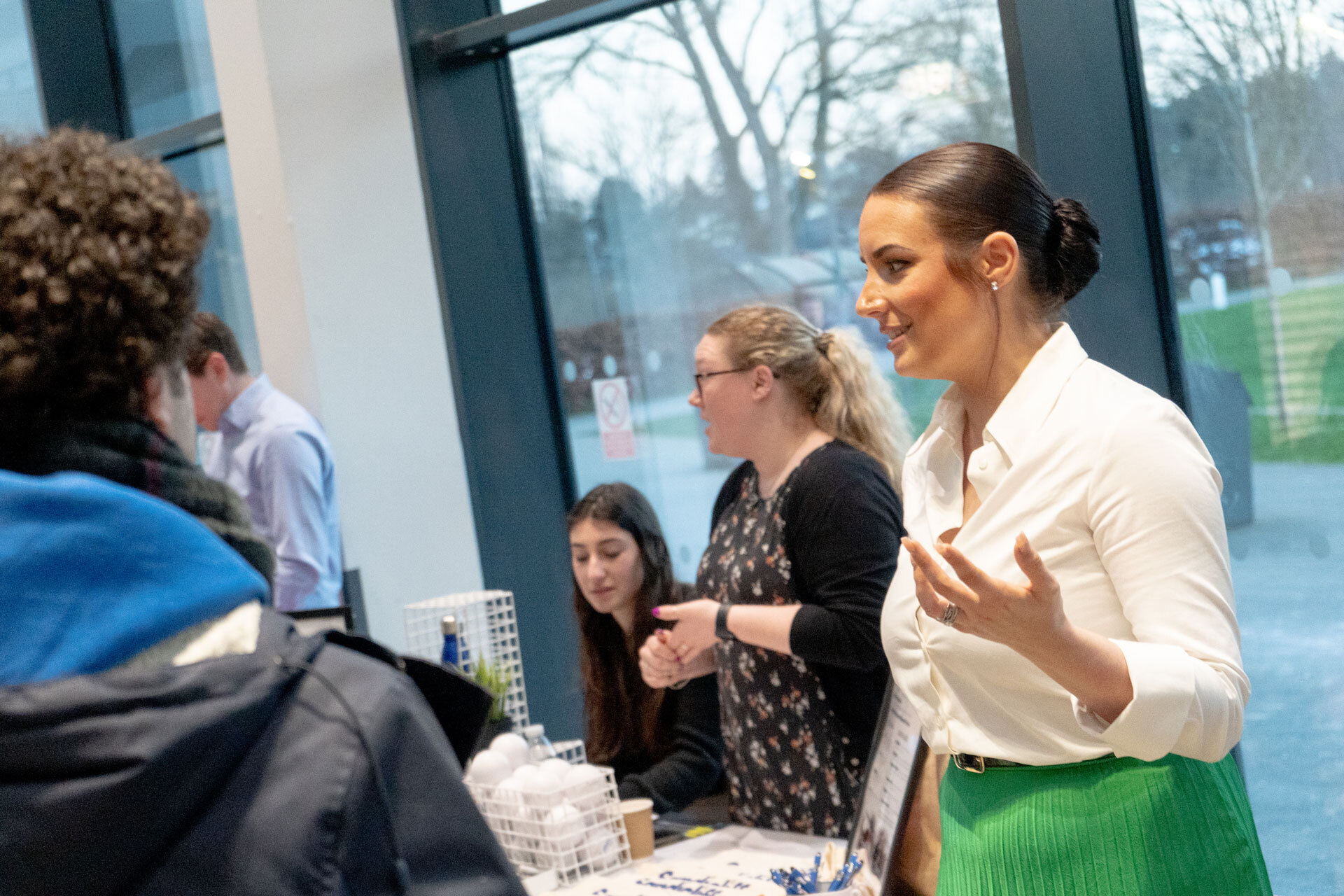 A member of staff explaining something to a student at an Open Evening