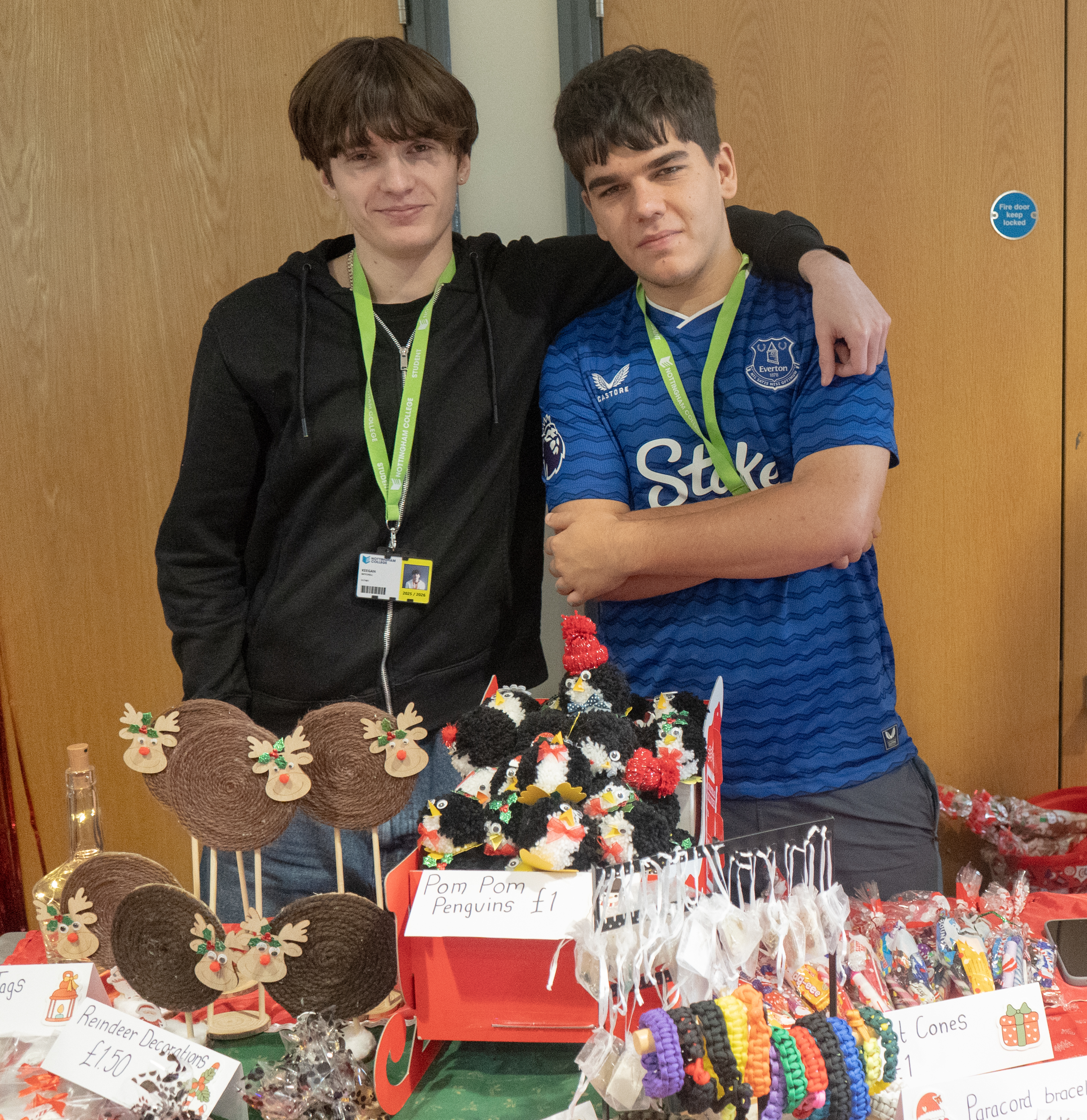 Two students smiling at their stall selling jewellery