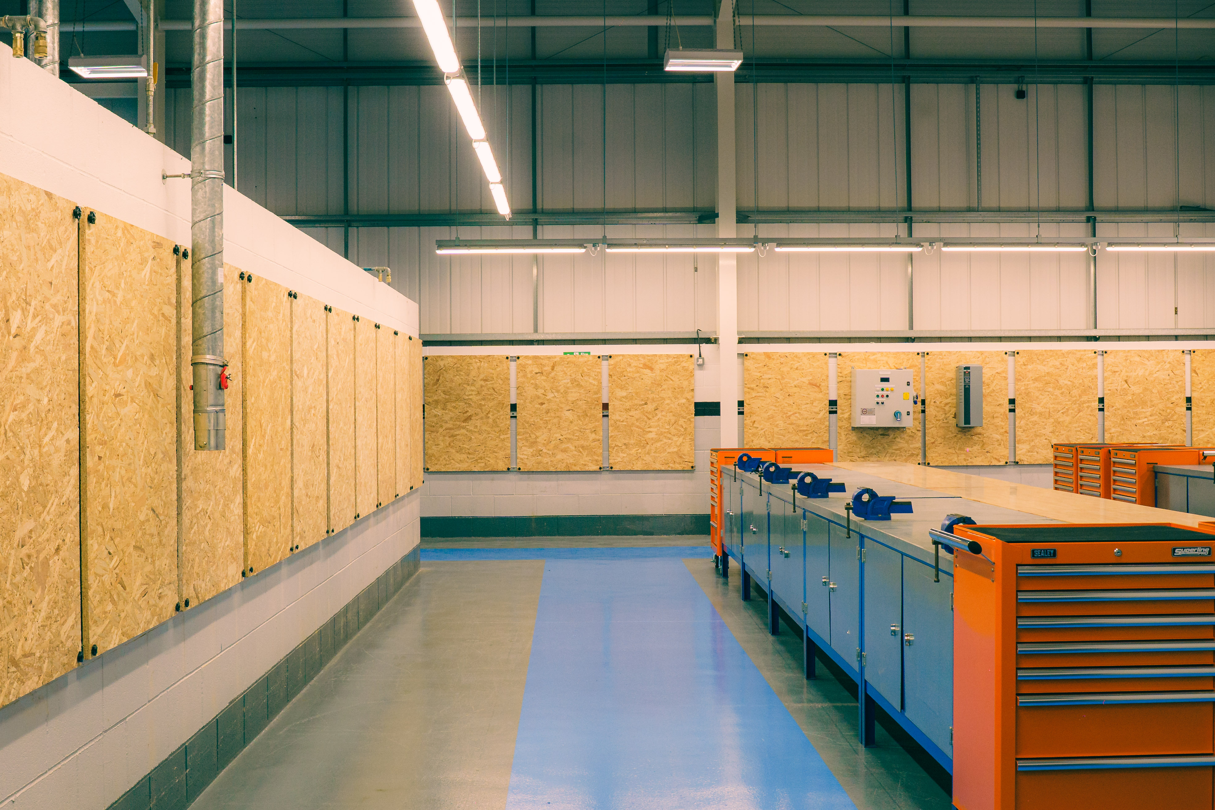 Workbenches with panels on a back wall