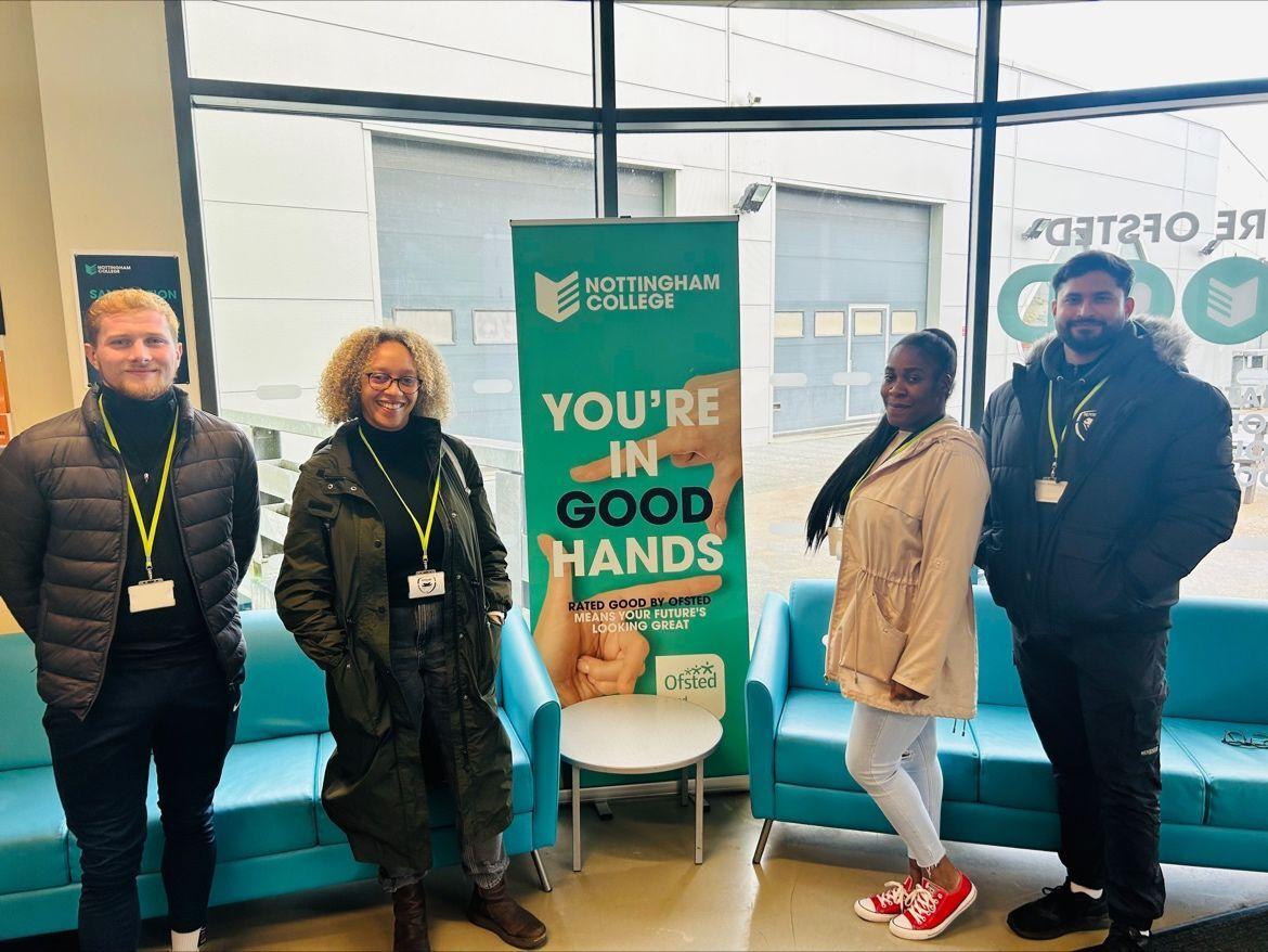 A group of people standing around a banner stating 'Nottingham College - you're in good hands'.