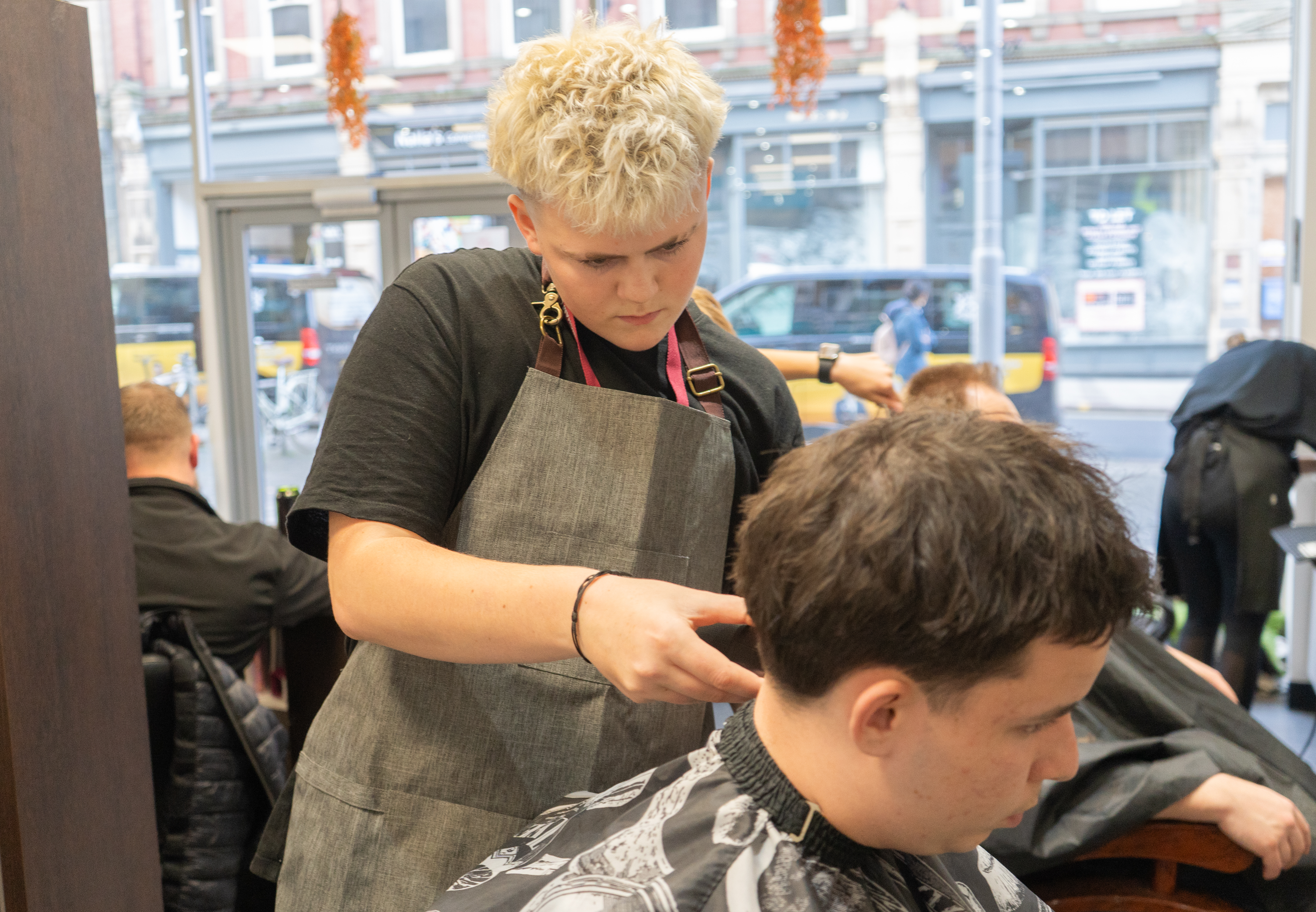 Hairdressing student cutting a clients hair