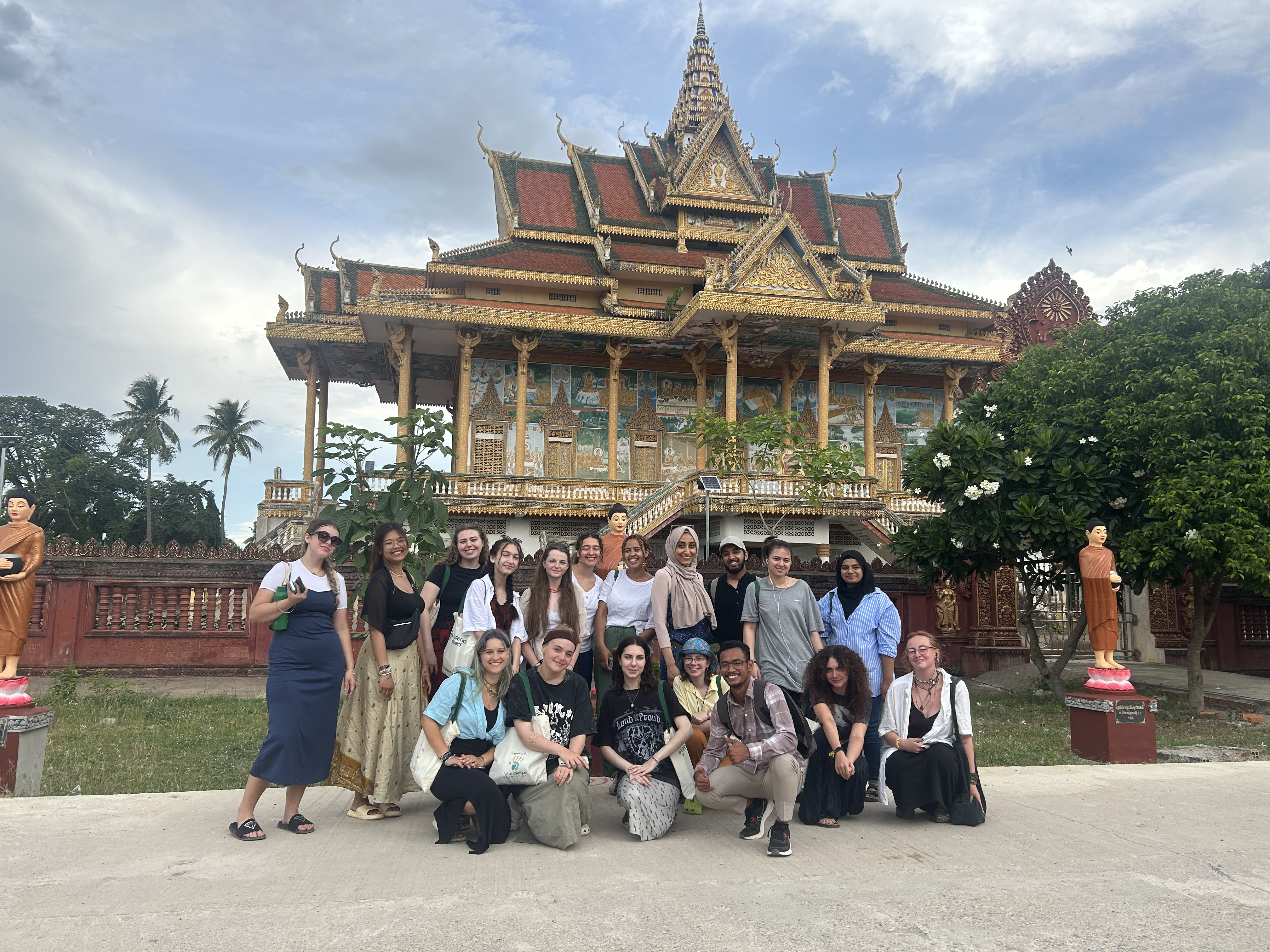 Students and staff stood in front of a building