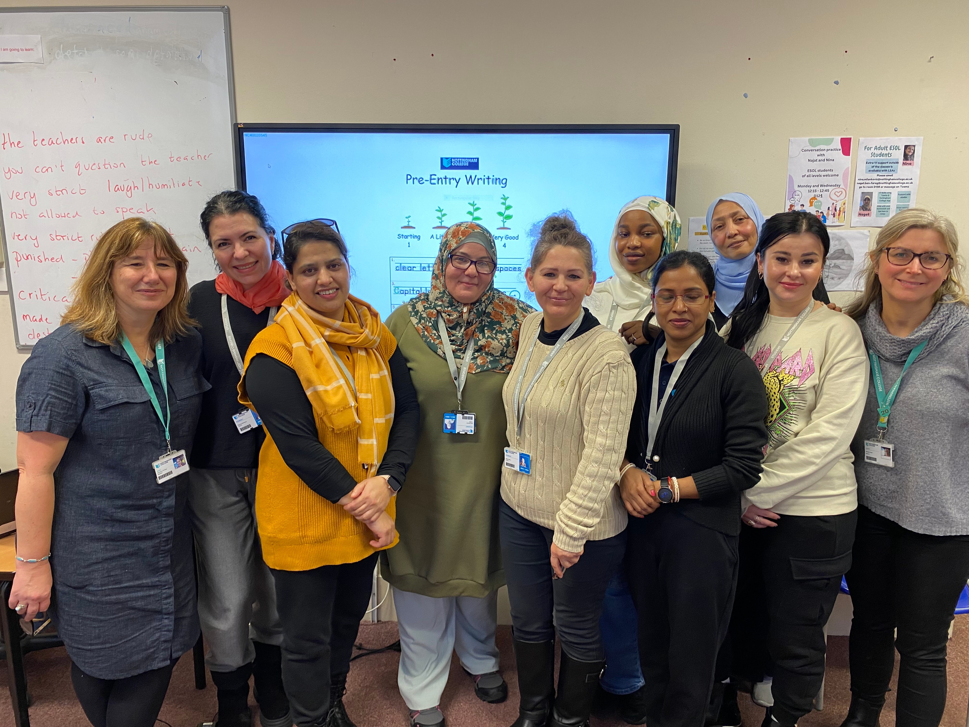 Learners on the ESOL+ pathway and staff smiling at the camera