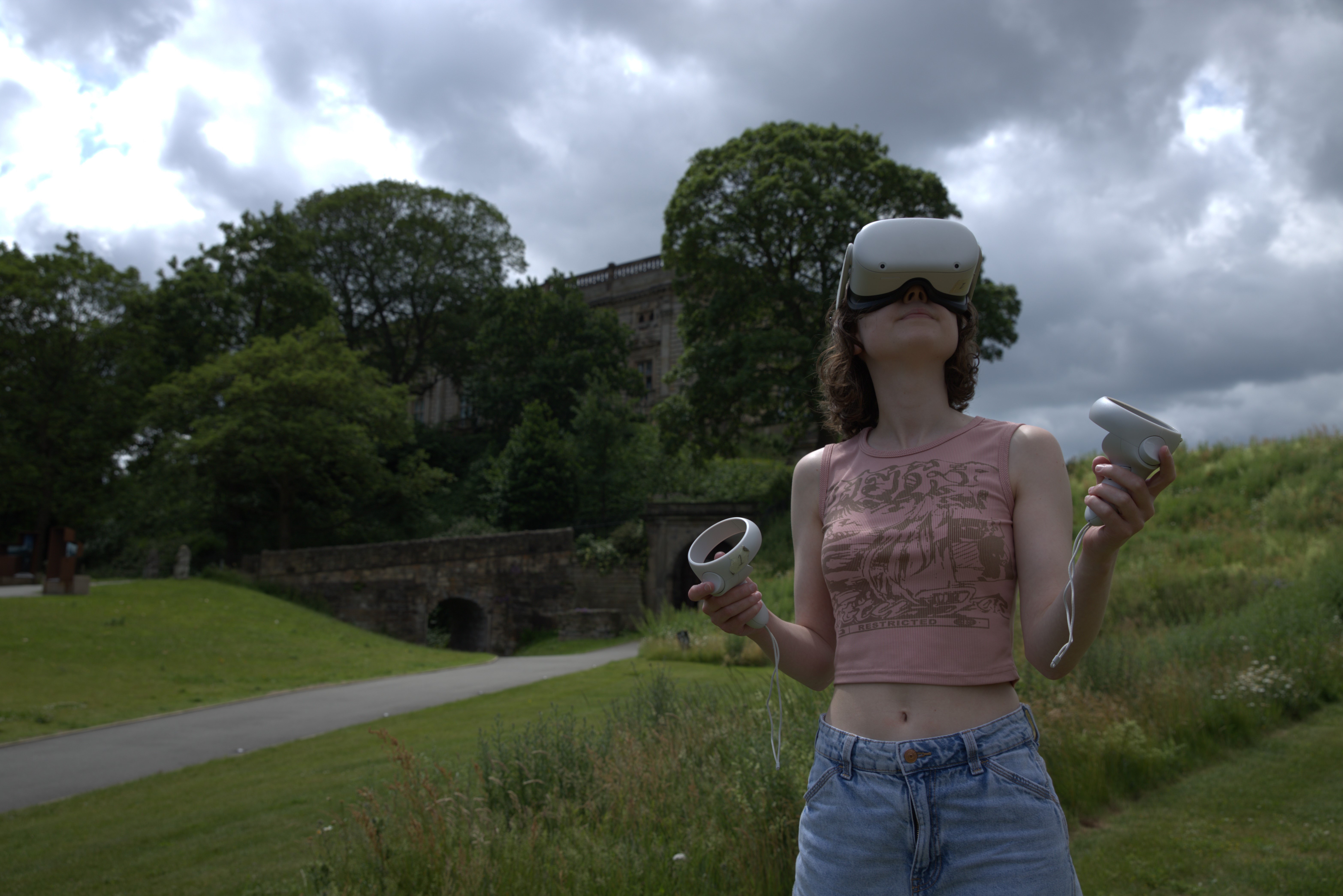 Woman wearing a VR headset in front of Nottingham College
