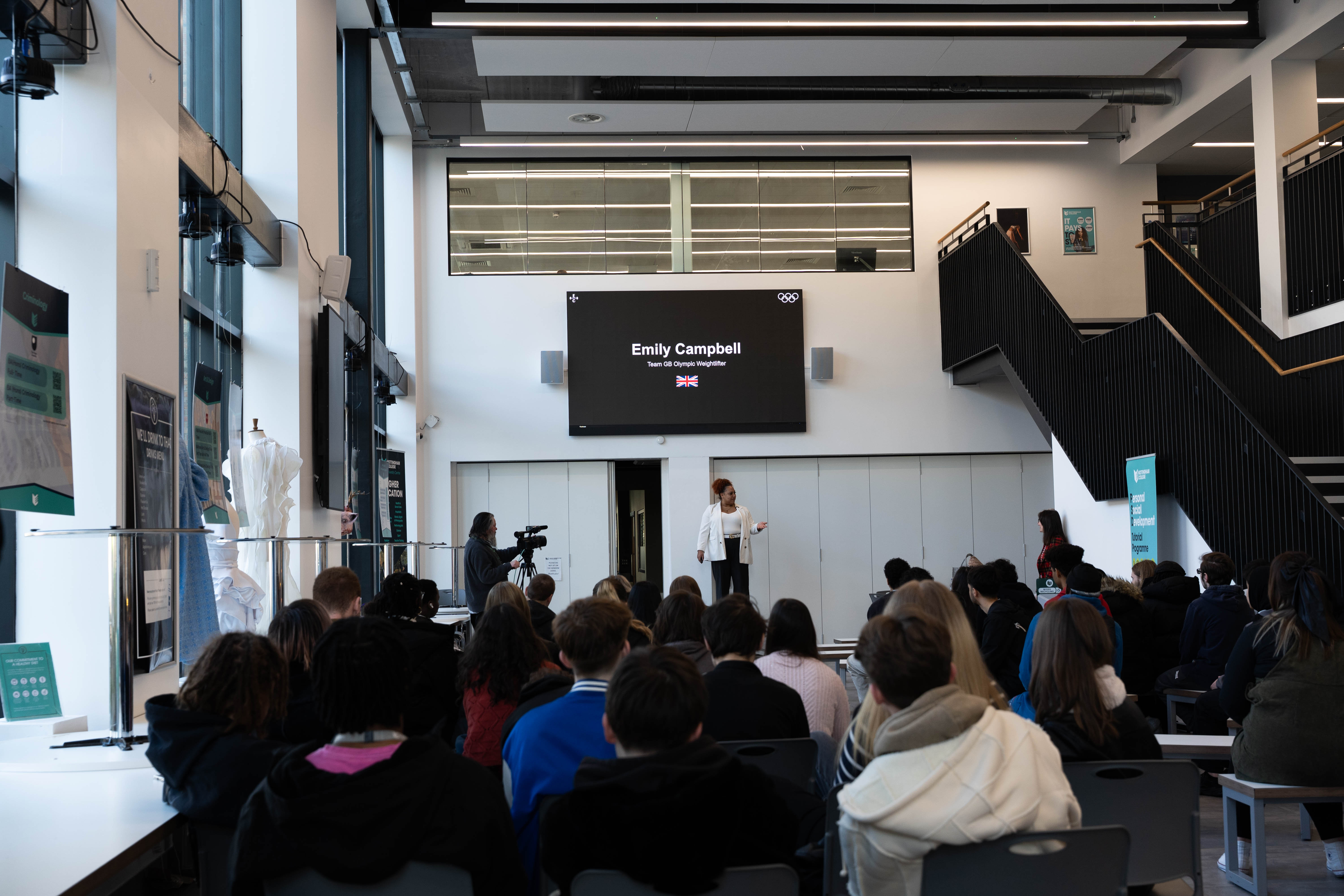 Emily Campbell in the atrium of the City Hub speaking to a group of students