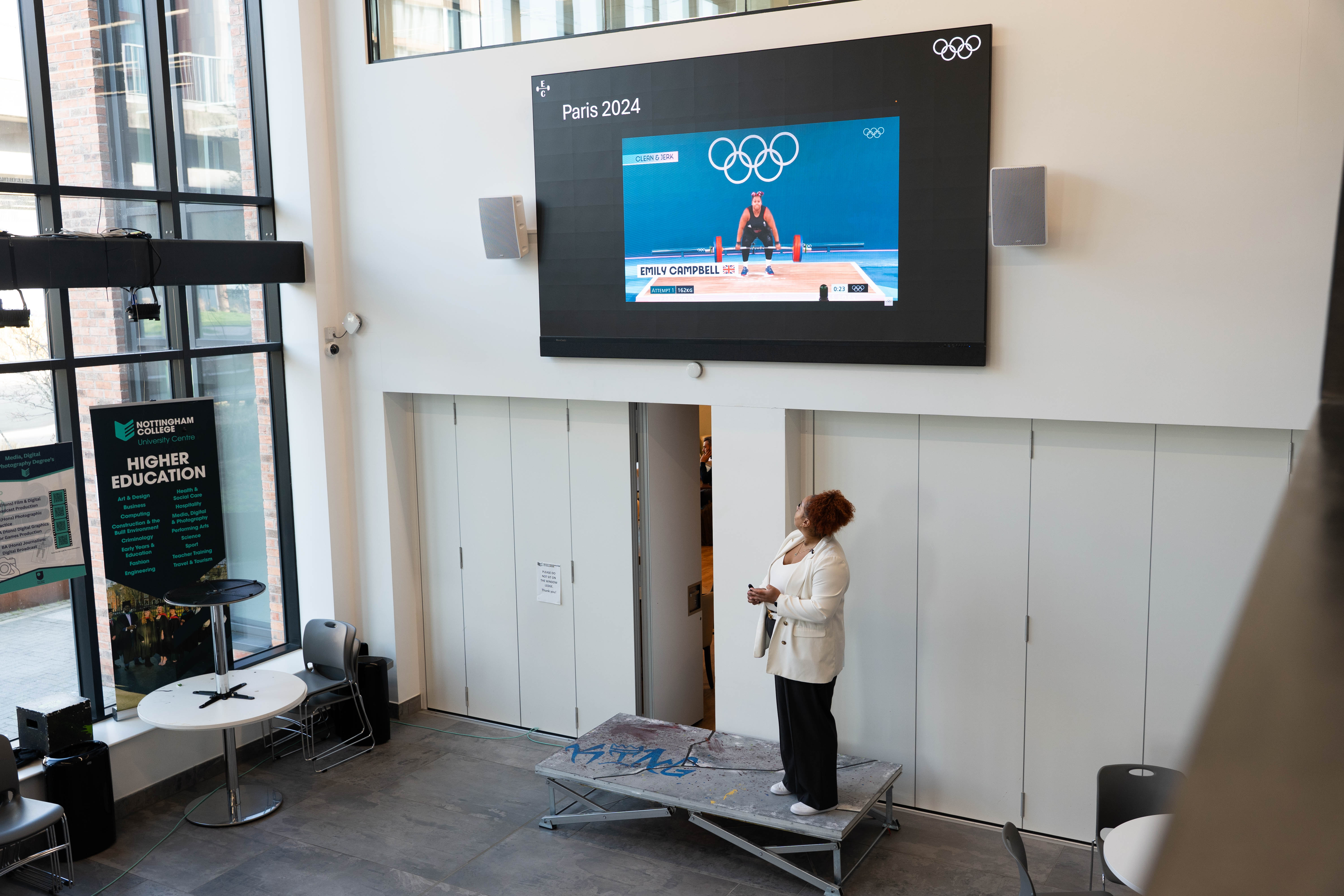 Emily Campbell alongside a video of her performance at the Tokyo Olympic games