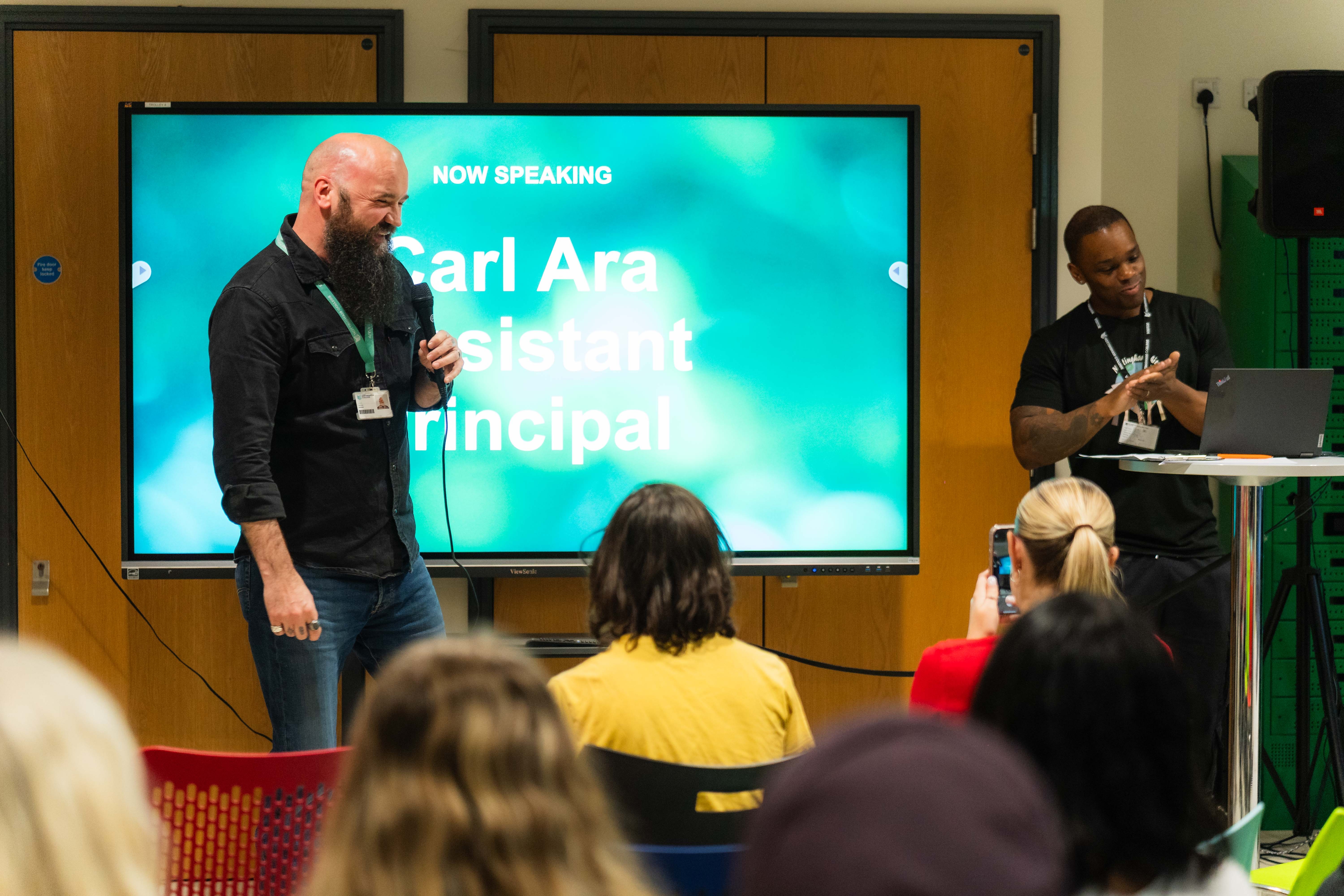 Carl speaking at the front of the stage
