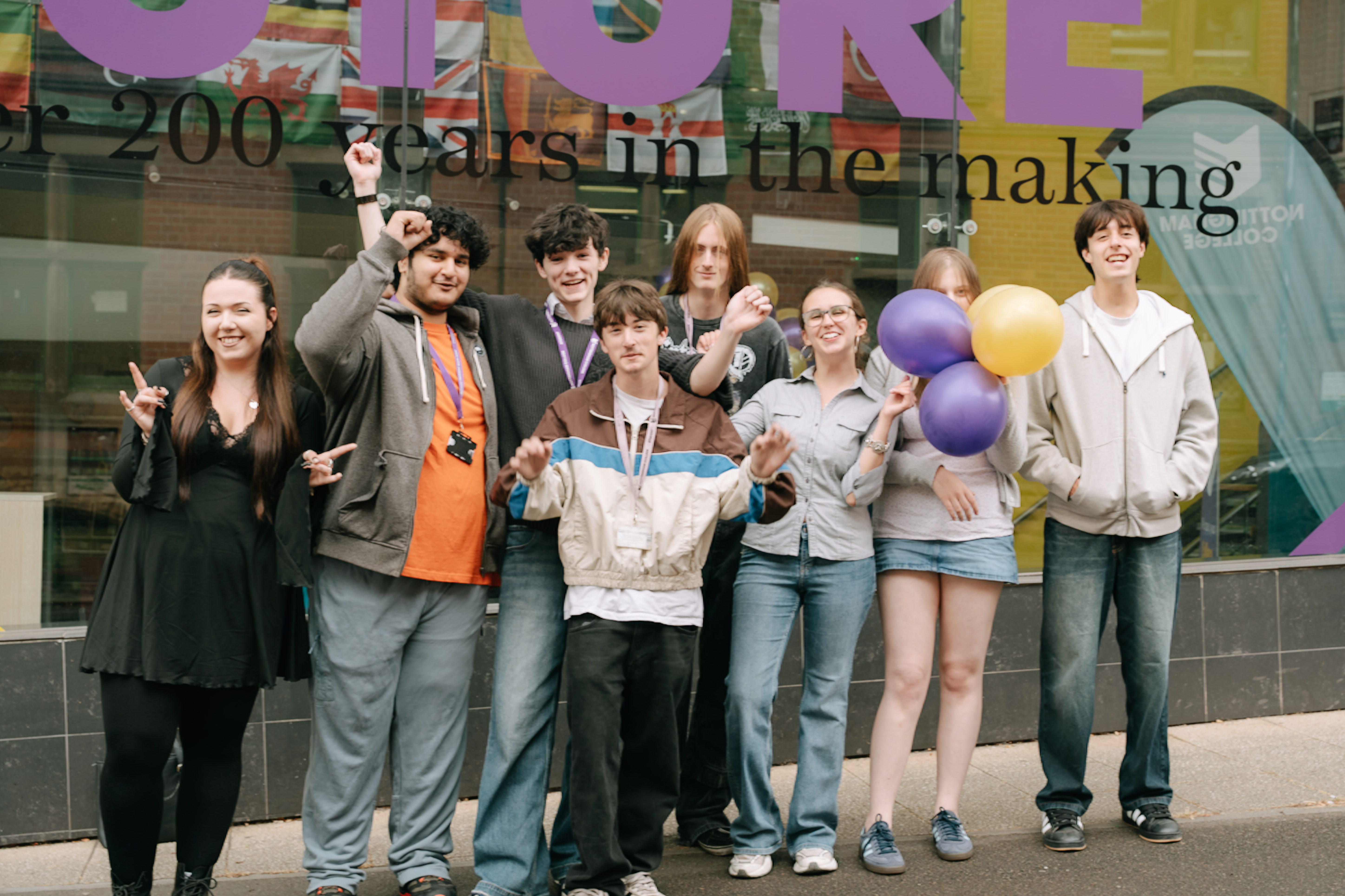 8 students celebrating their results in front of our High Pavement campus