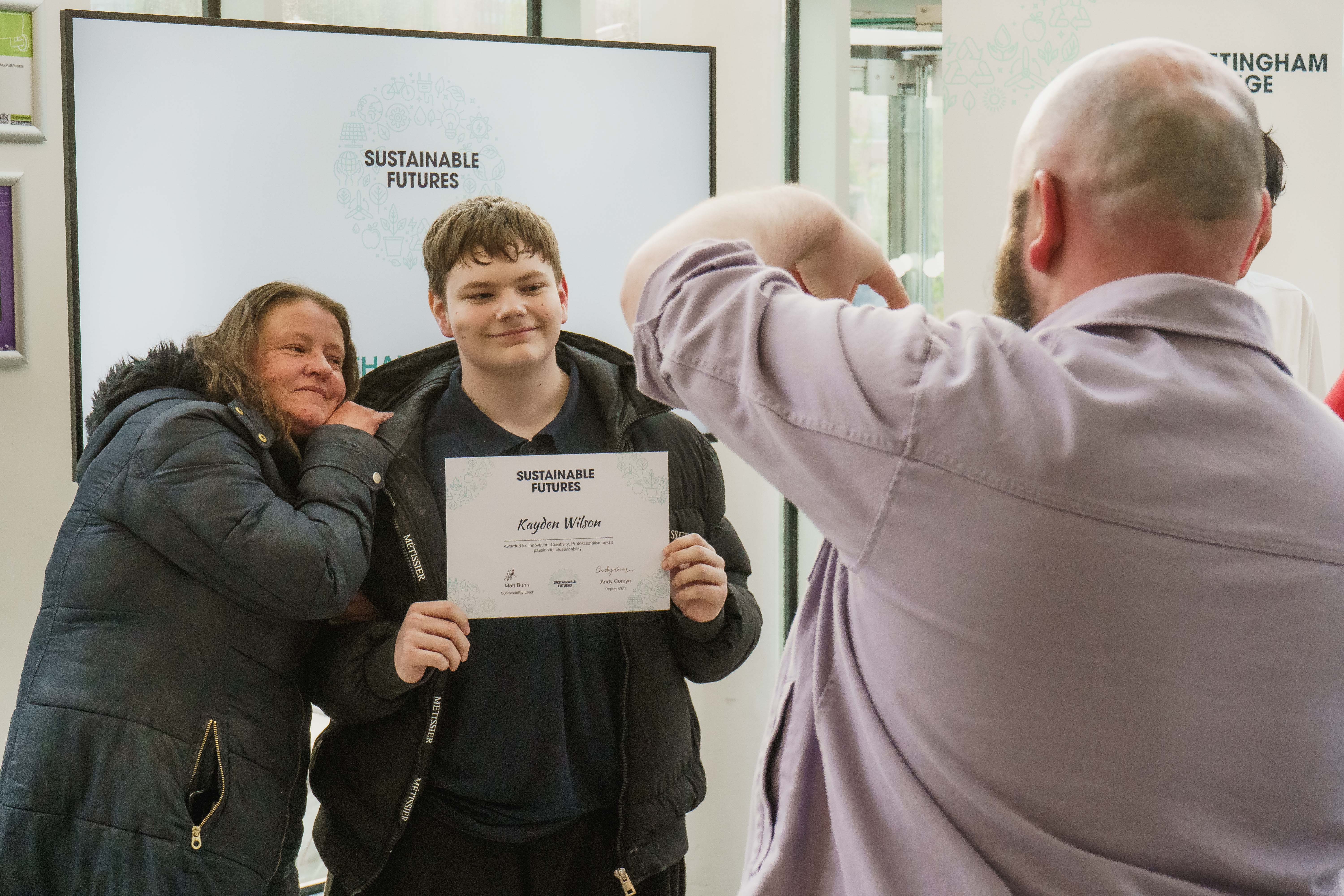 Student posing for a picture with his parent