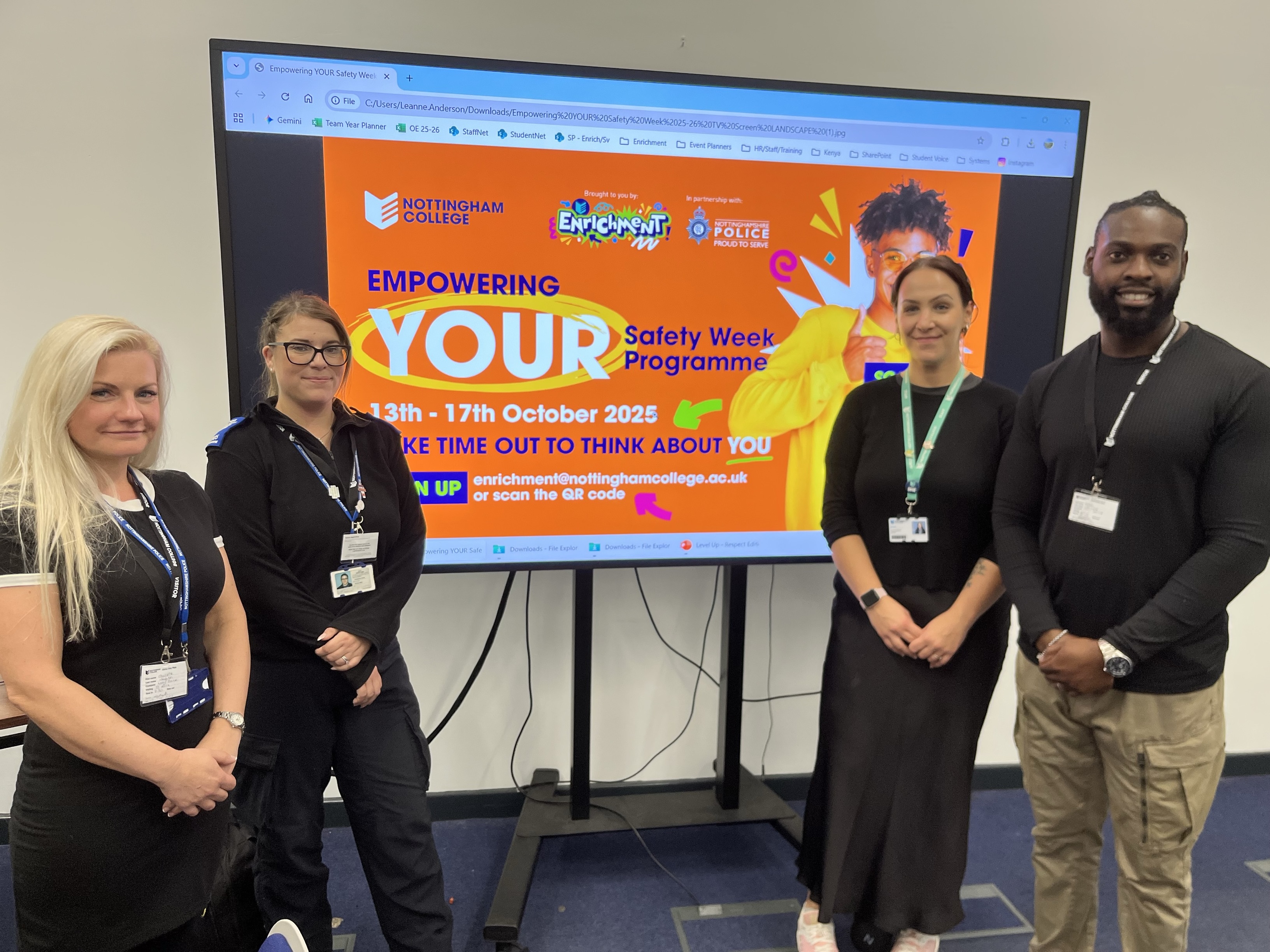 Four people stood infront of a screen that reads empower your safety
