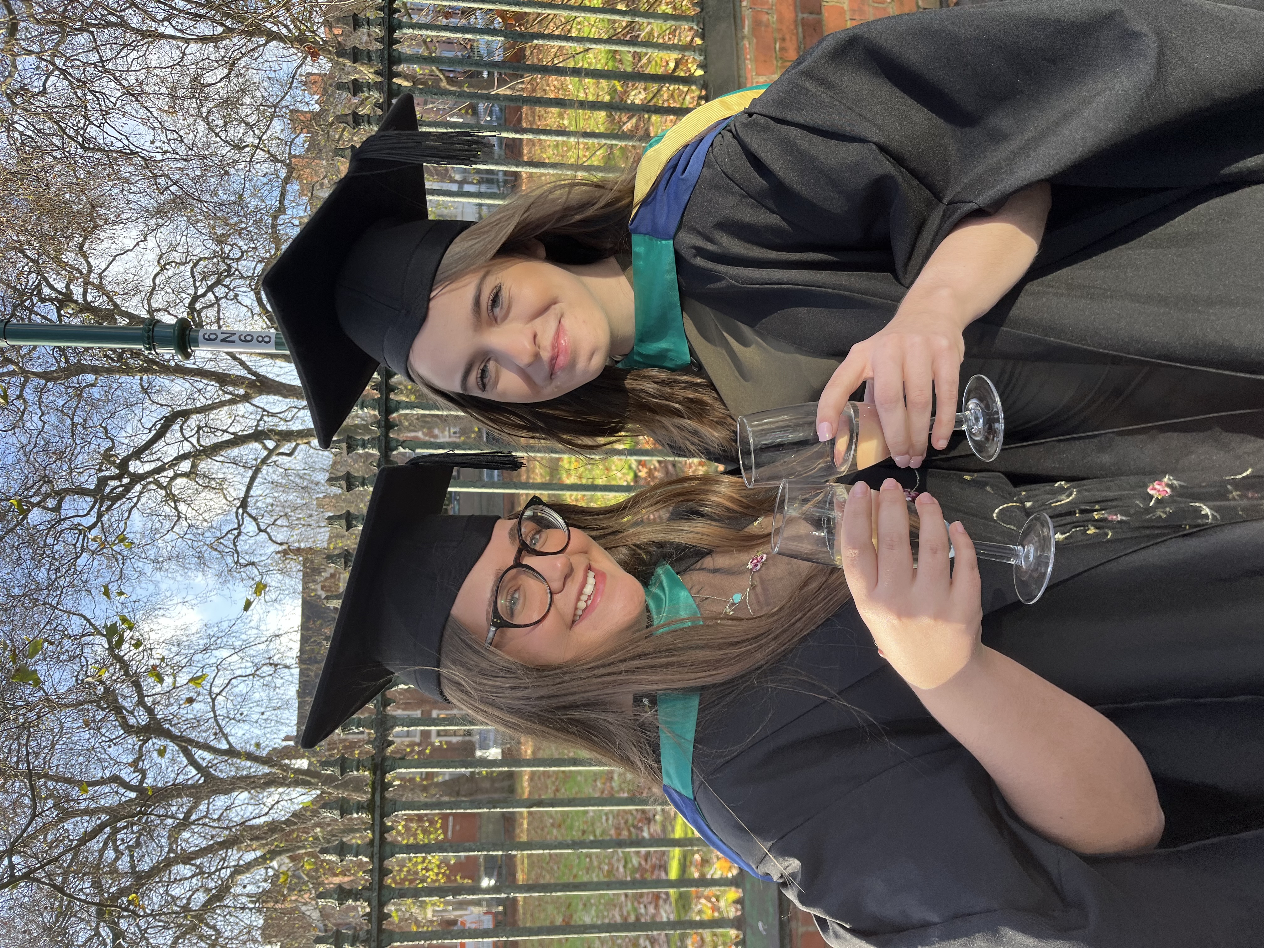 Two graduates smiling for the camera