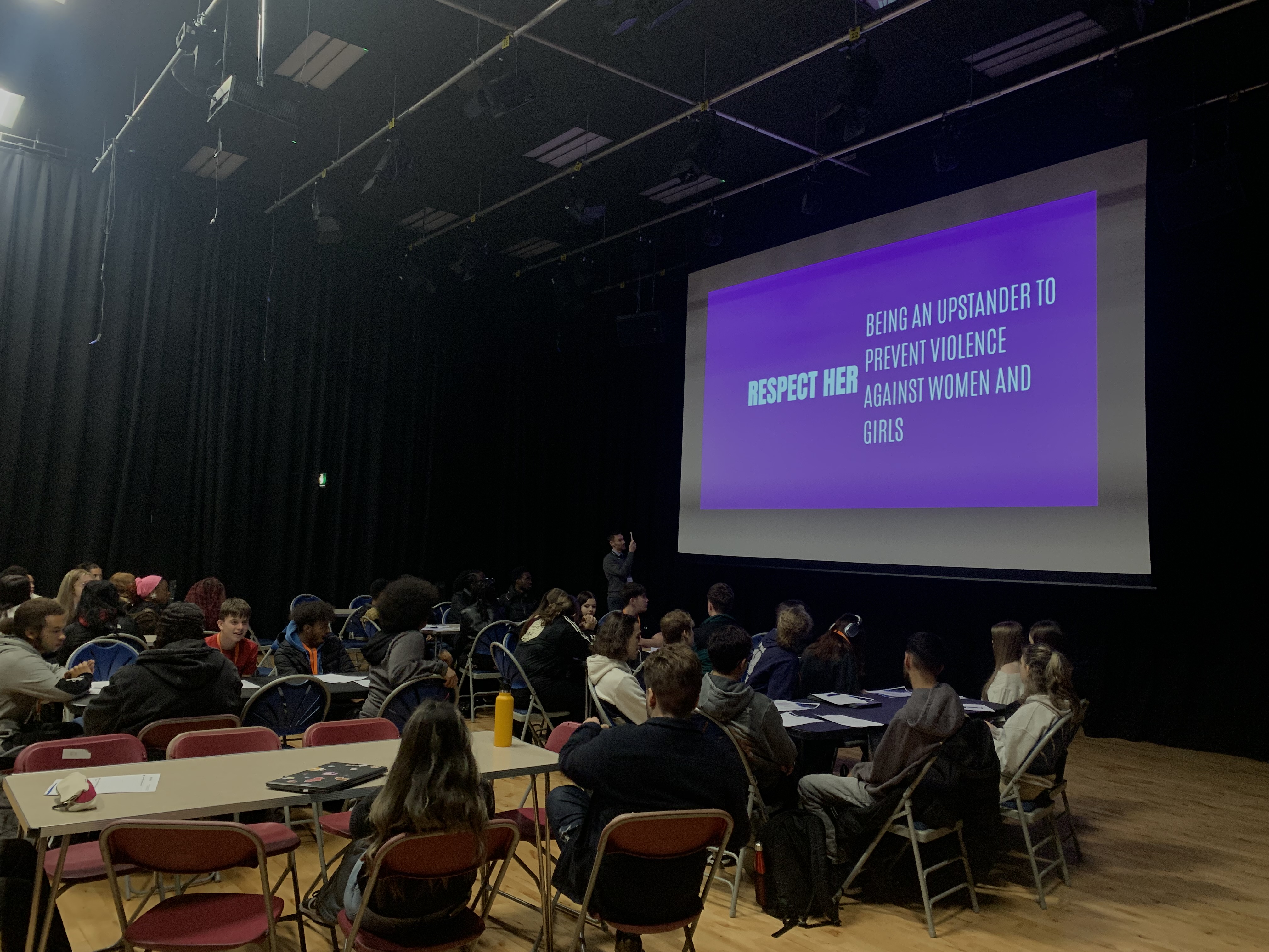 Students sat infront of a projected screen
