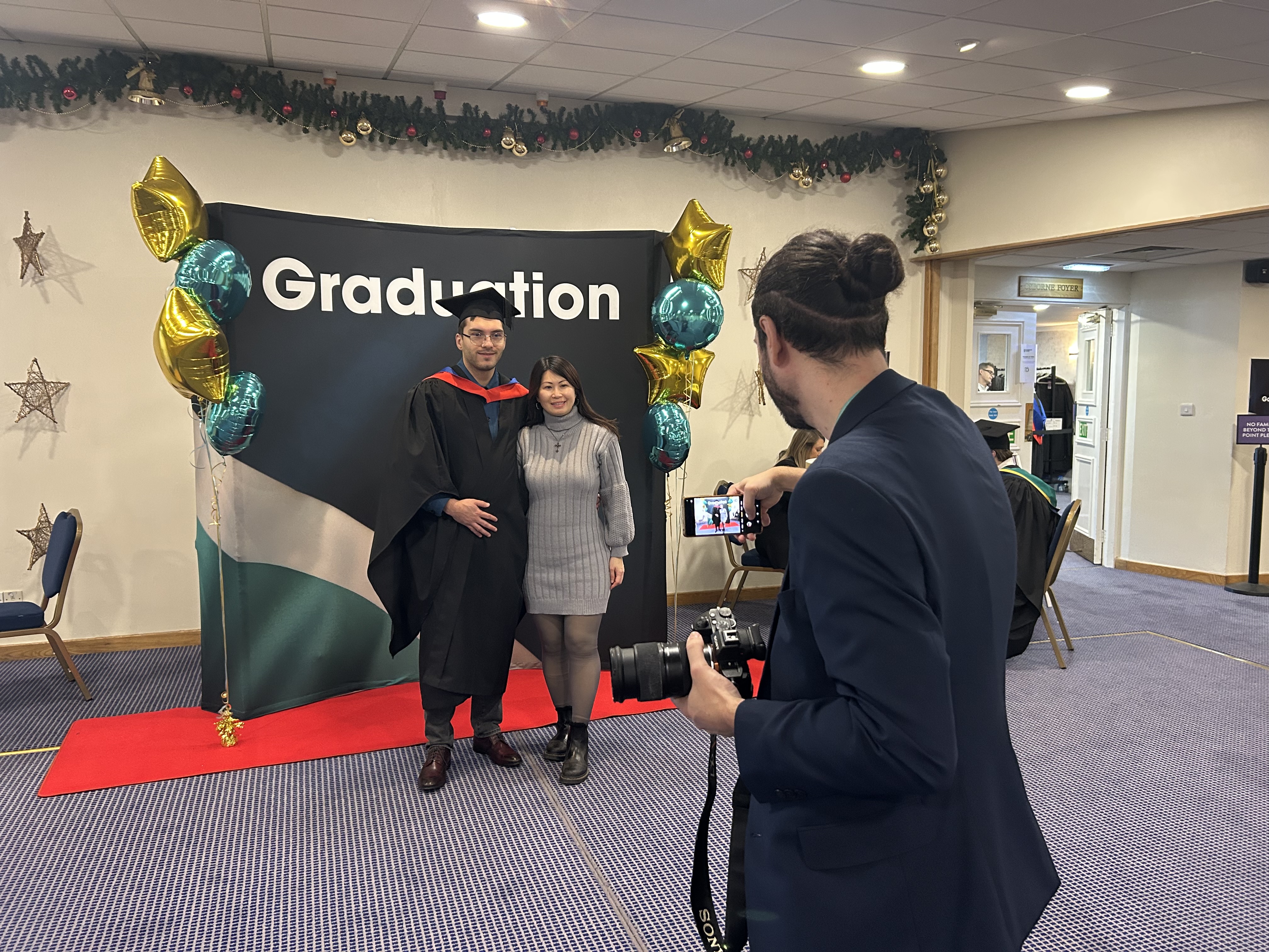 Graduate and guest getting their picture taken
