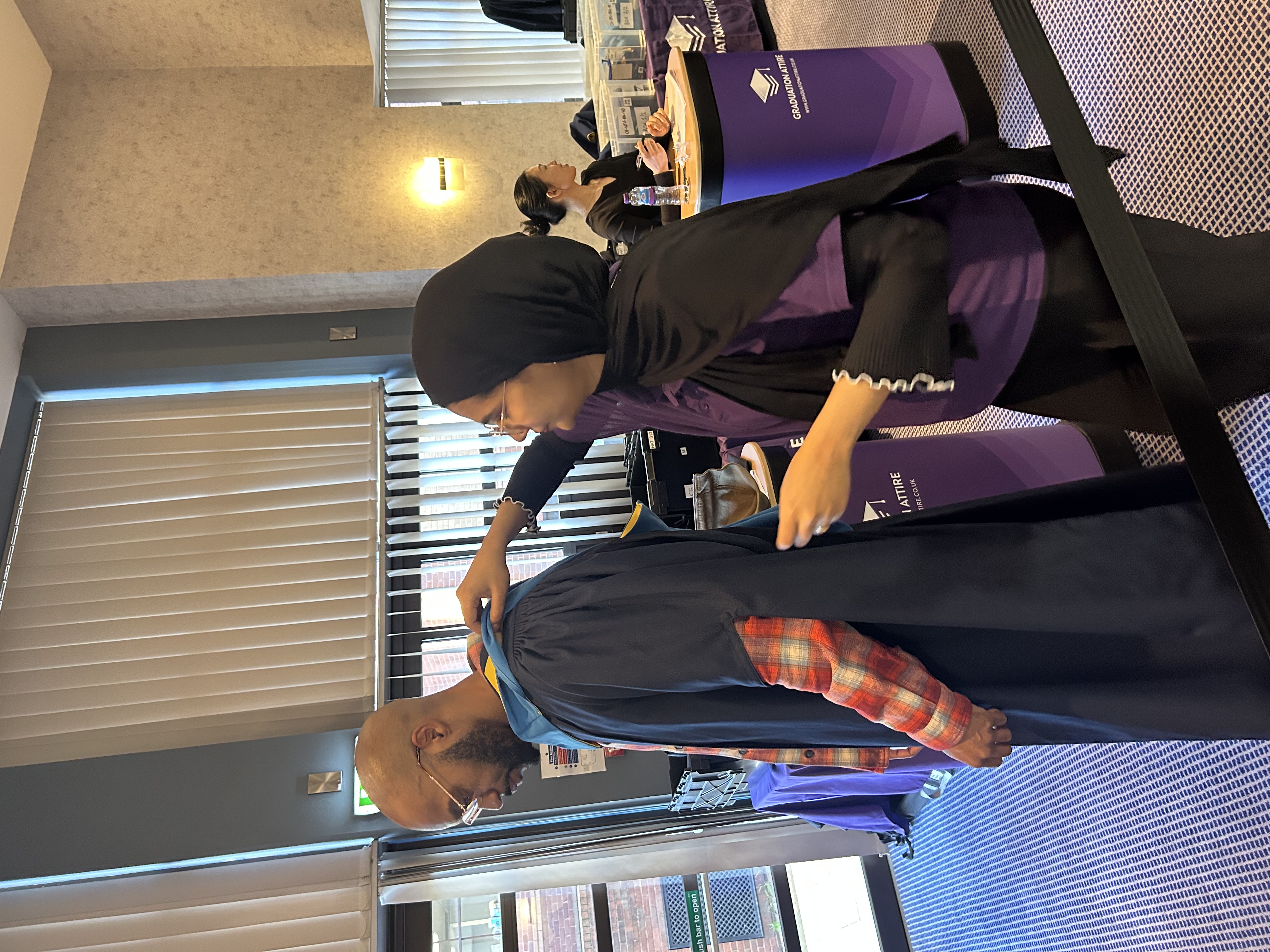 Graduate getting their gown fitted