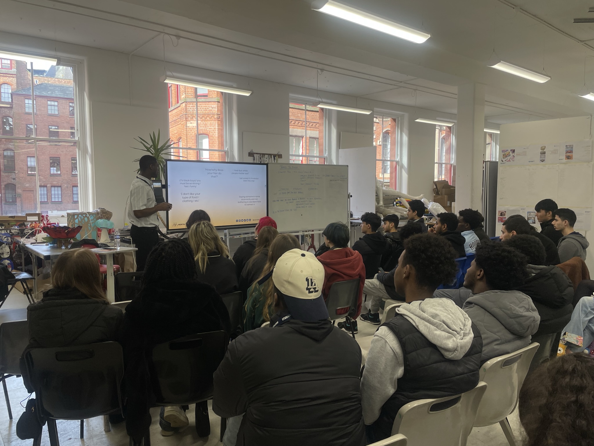 Nathan Addai stood by a big screen presenting to a group