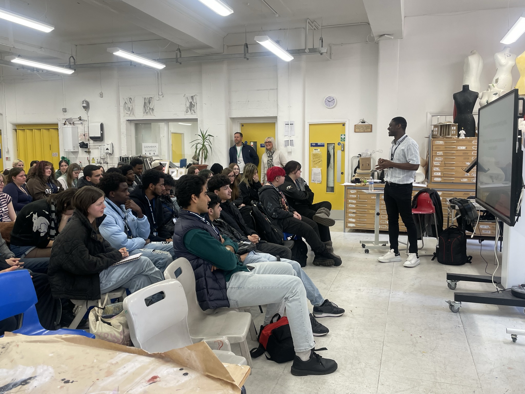 Nathan Addai presenting to a group of students
