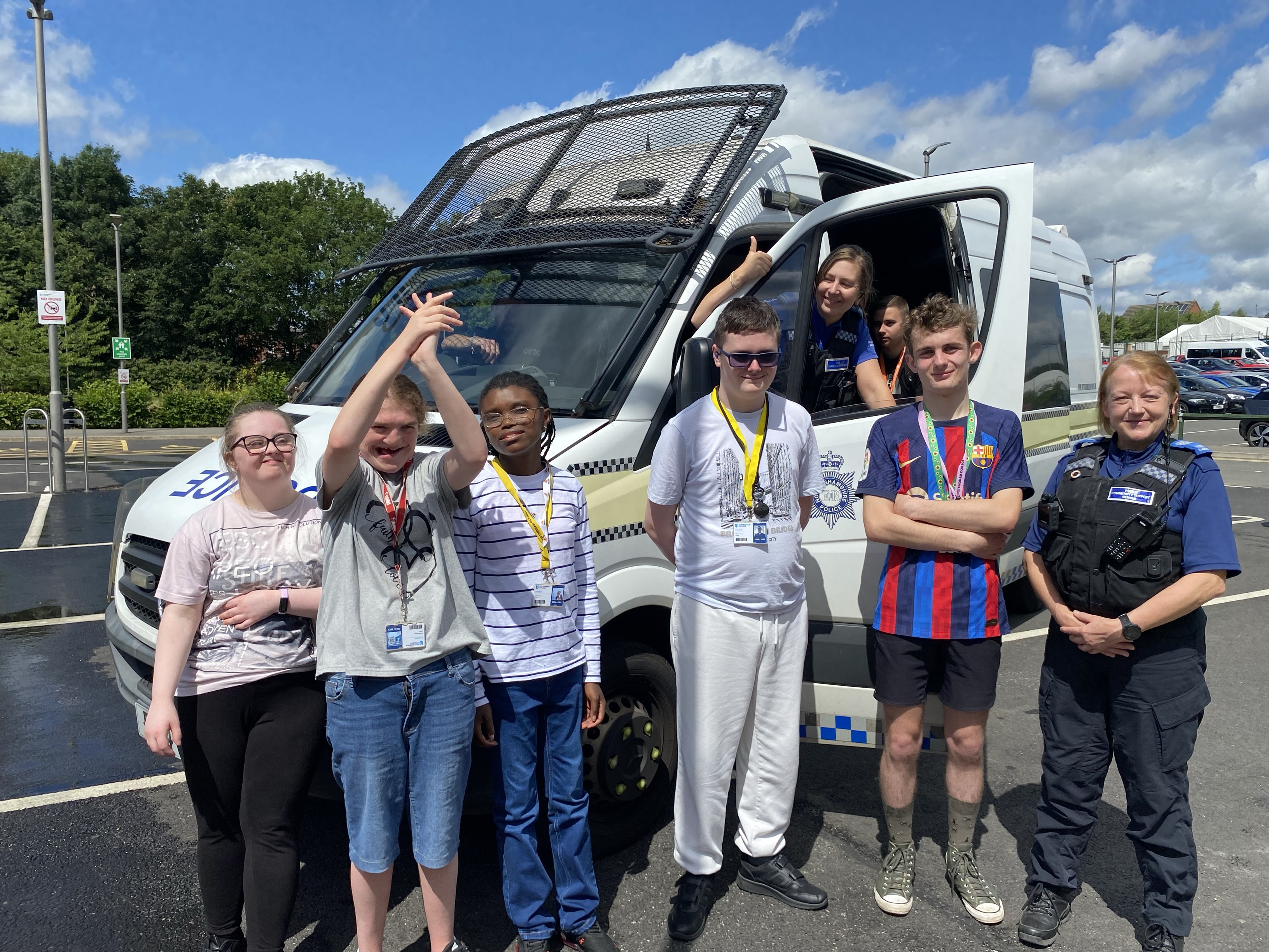 Students and police in front of a police van