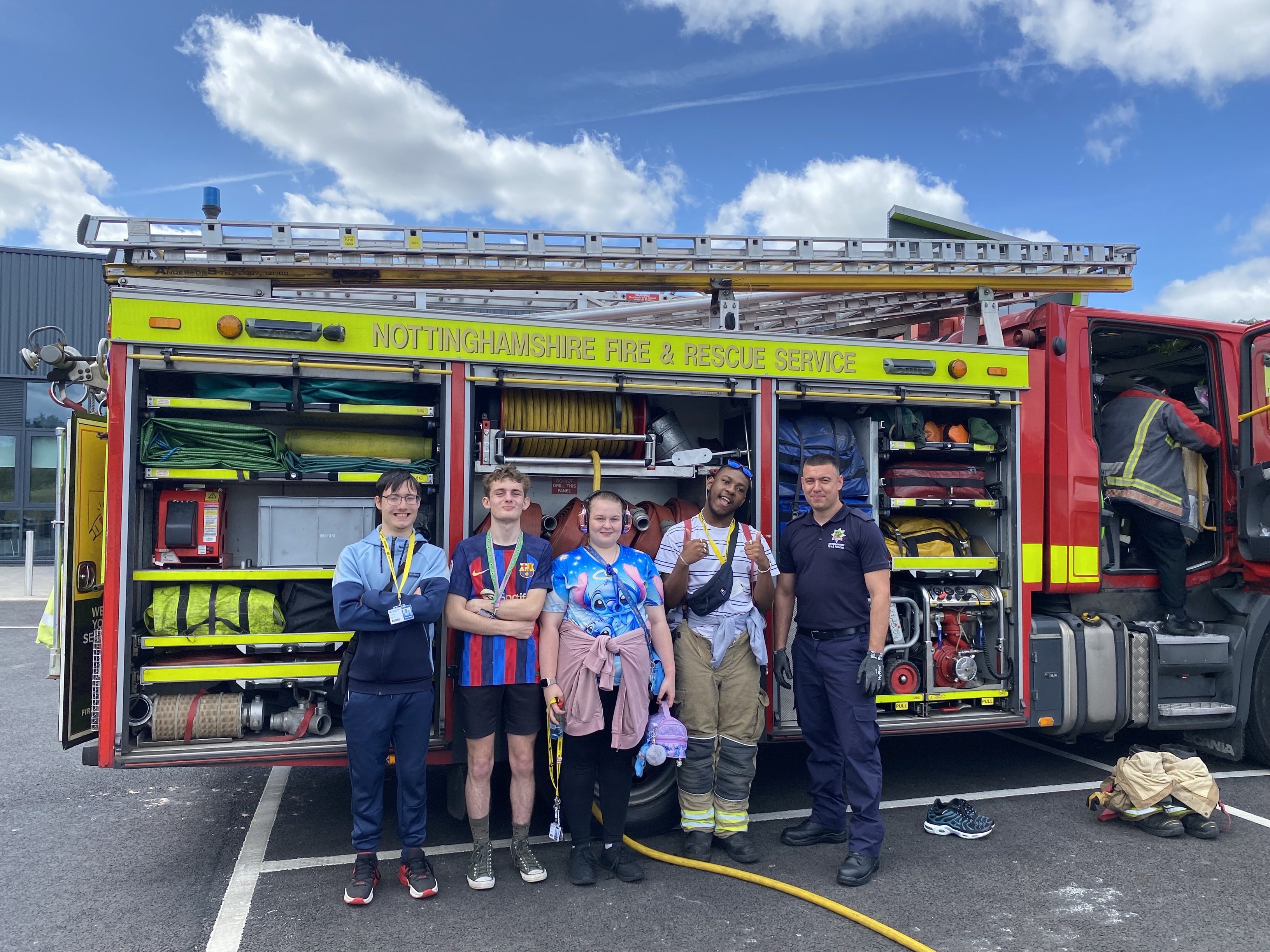 Students and fireman in front of a fire engine