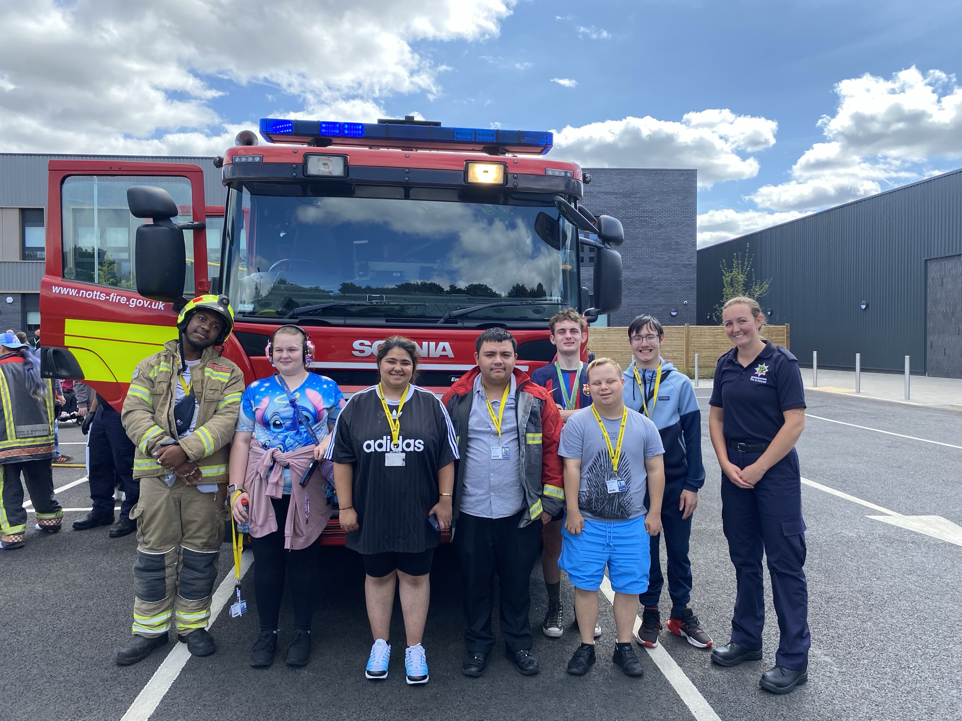 Students and firemen in front of a fire engine