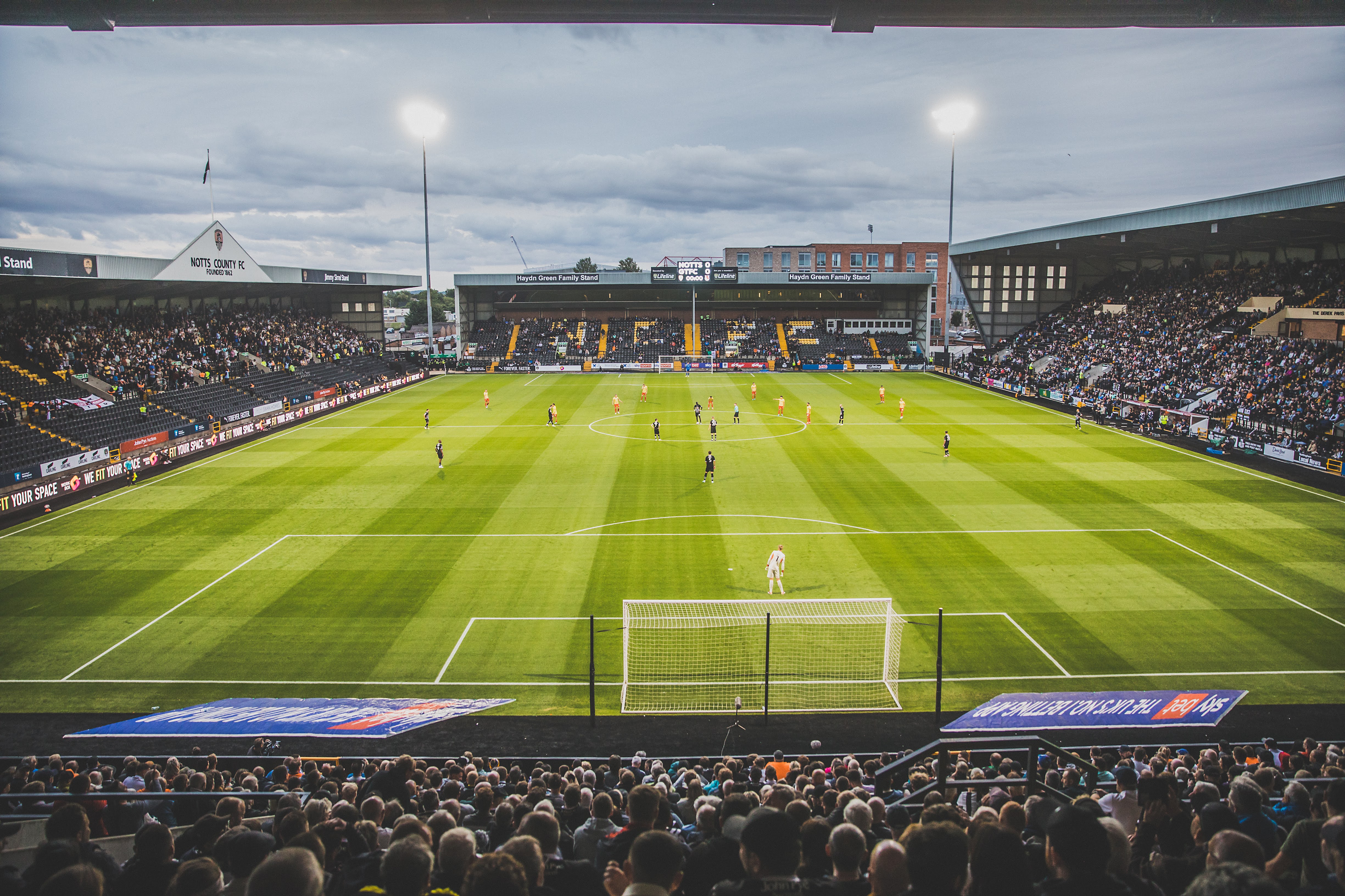 Fans watching their teams play football at the football grounds