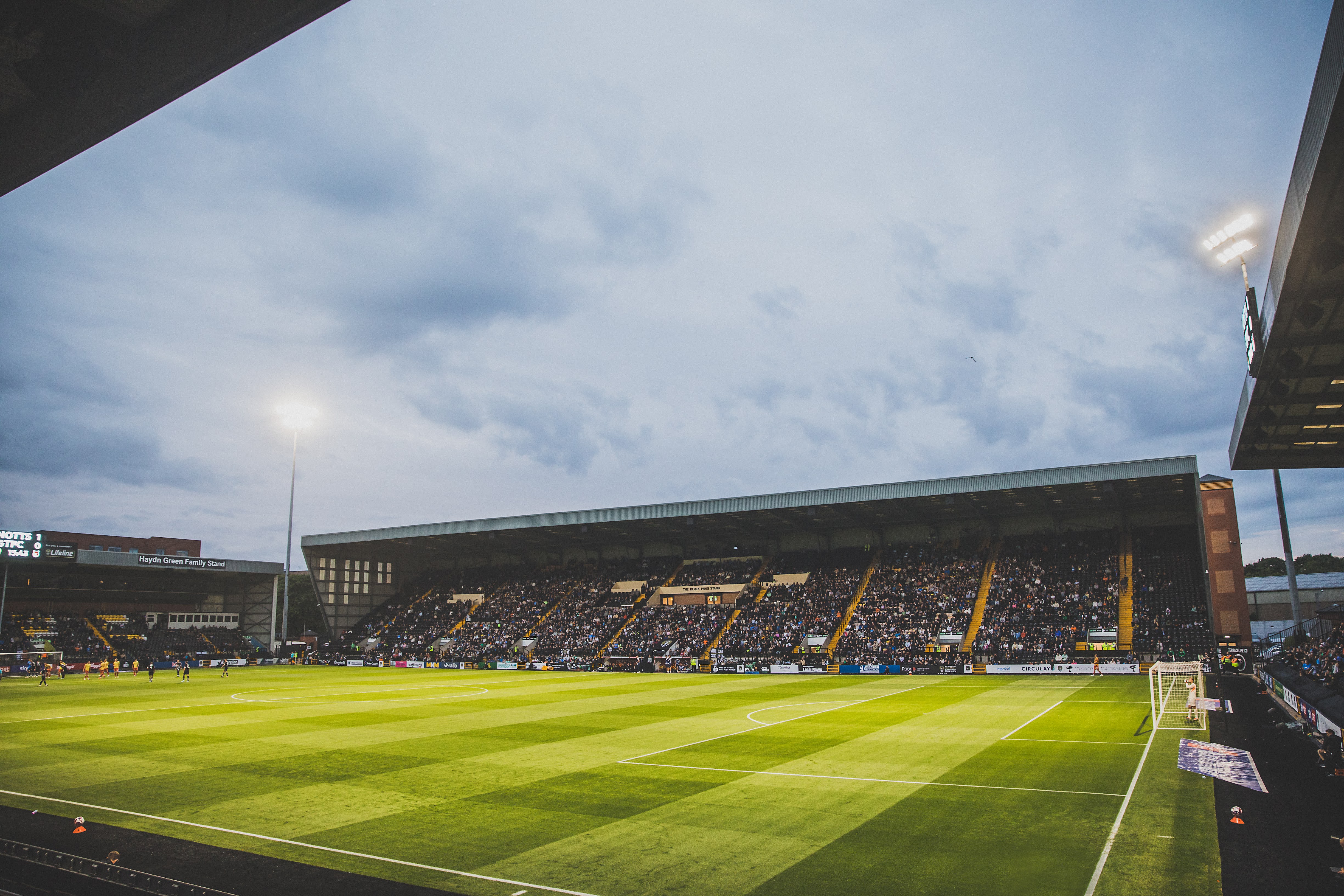 a picture of fans in the seats of a football ground