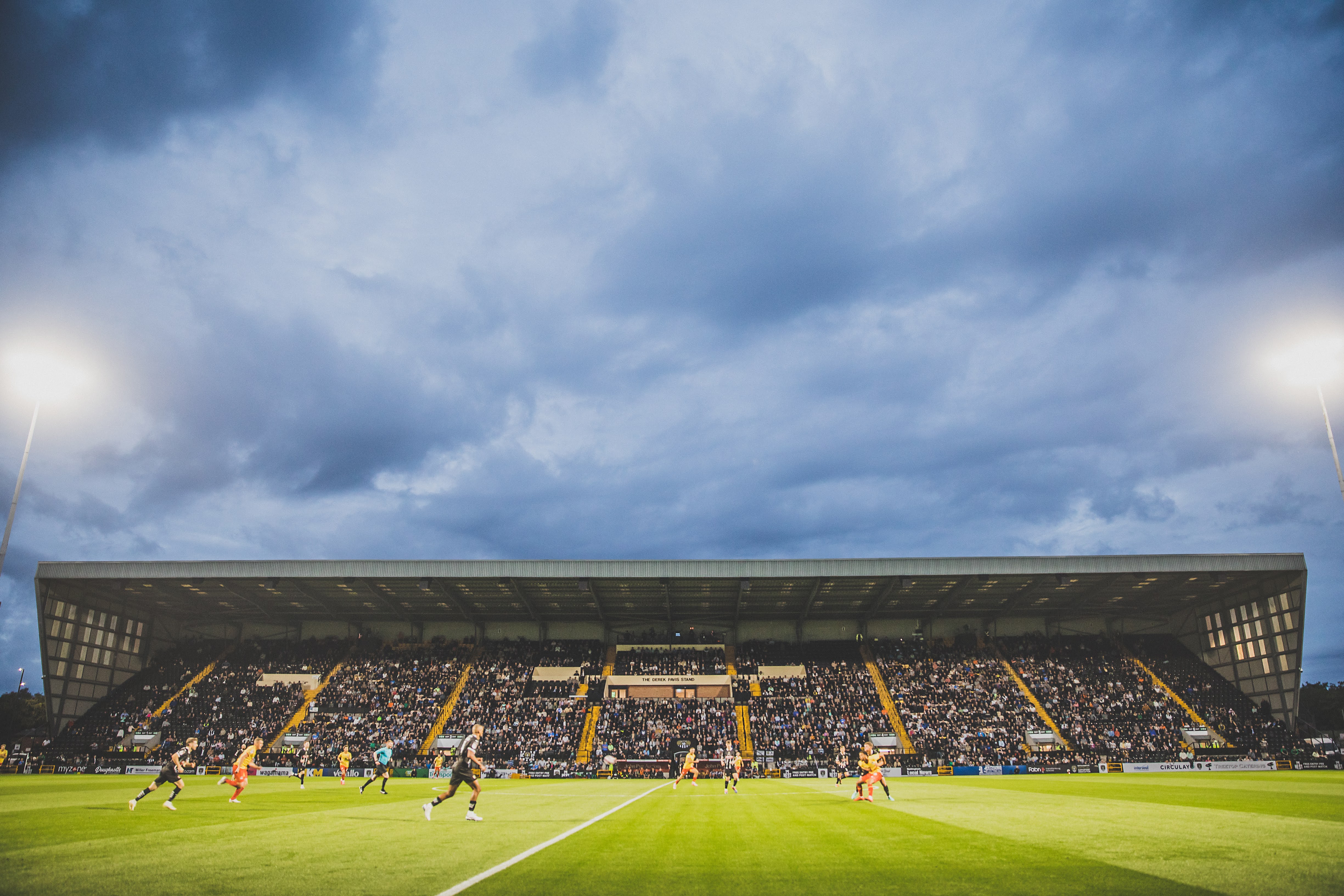 Footballers playing in a football ground