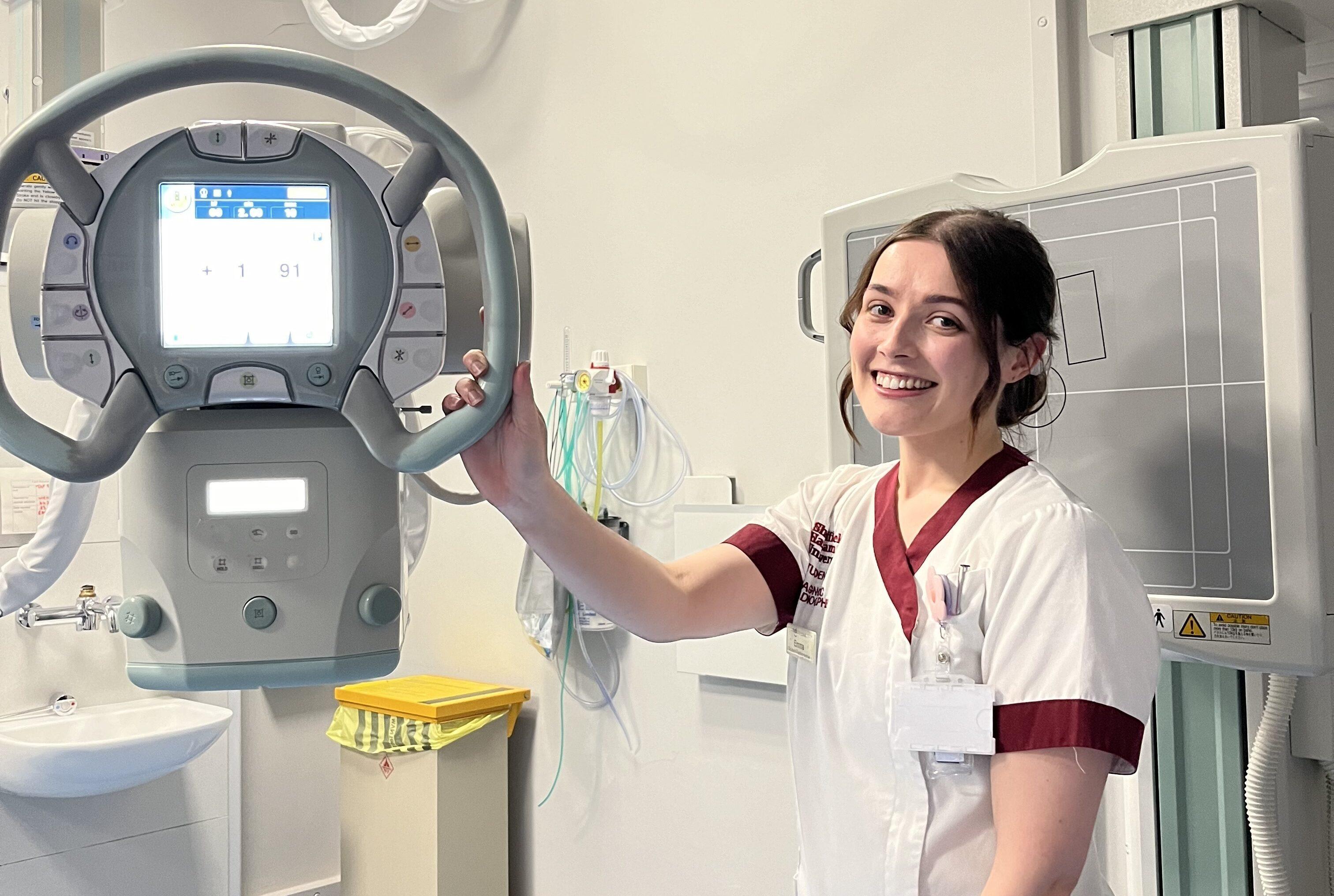 A picture of Emma next to an x-ray machine.