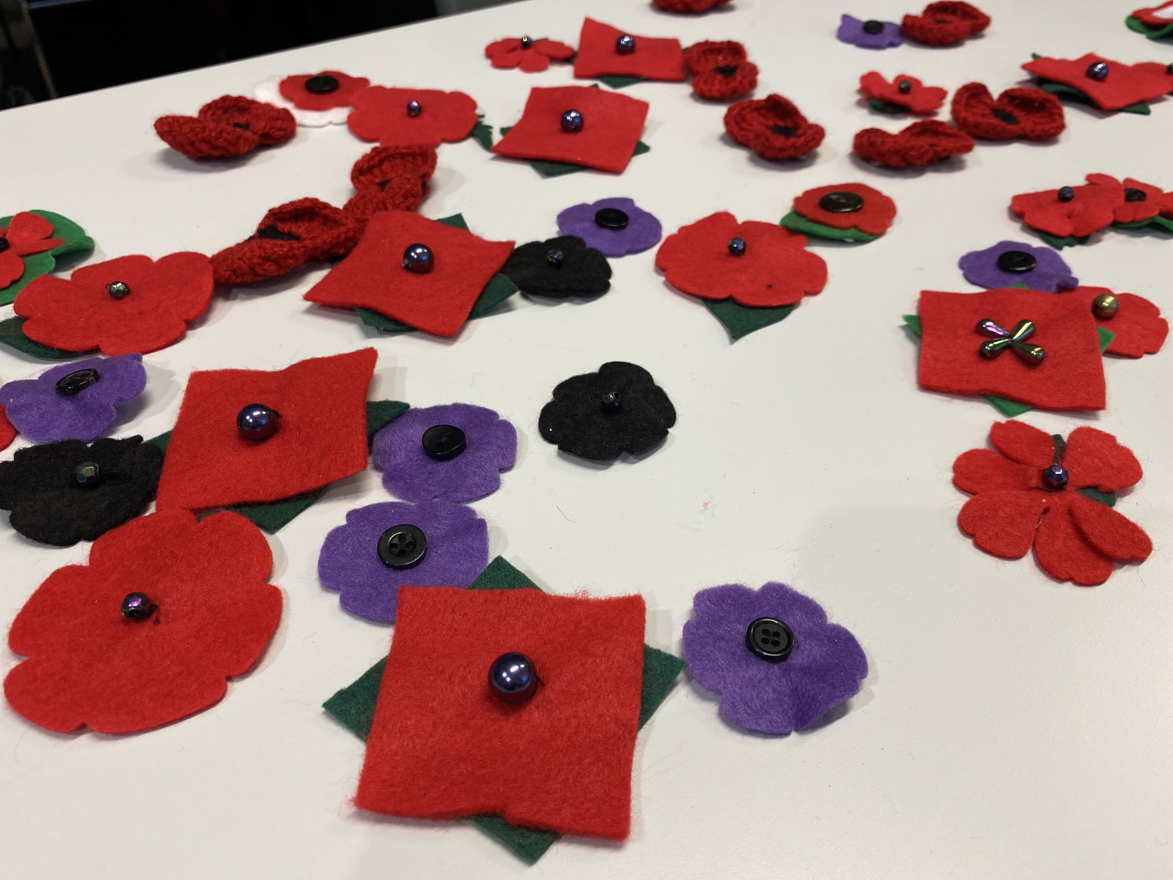 A selection of felt poppies on a table.