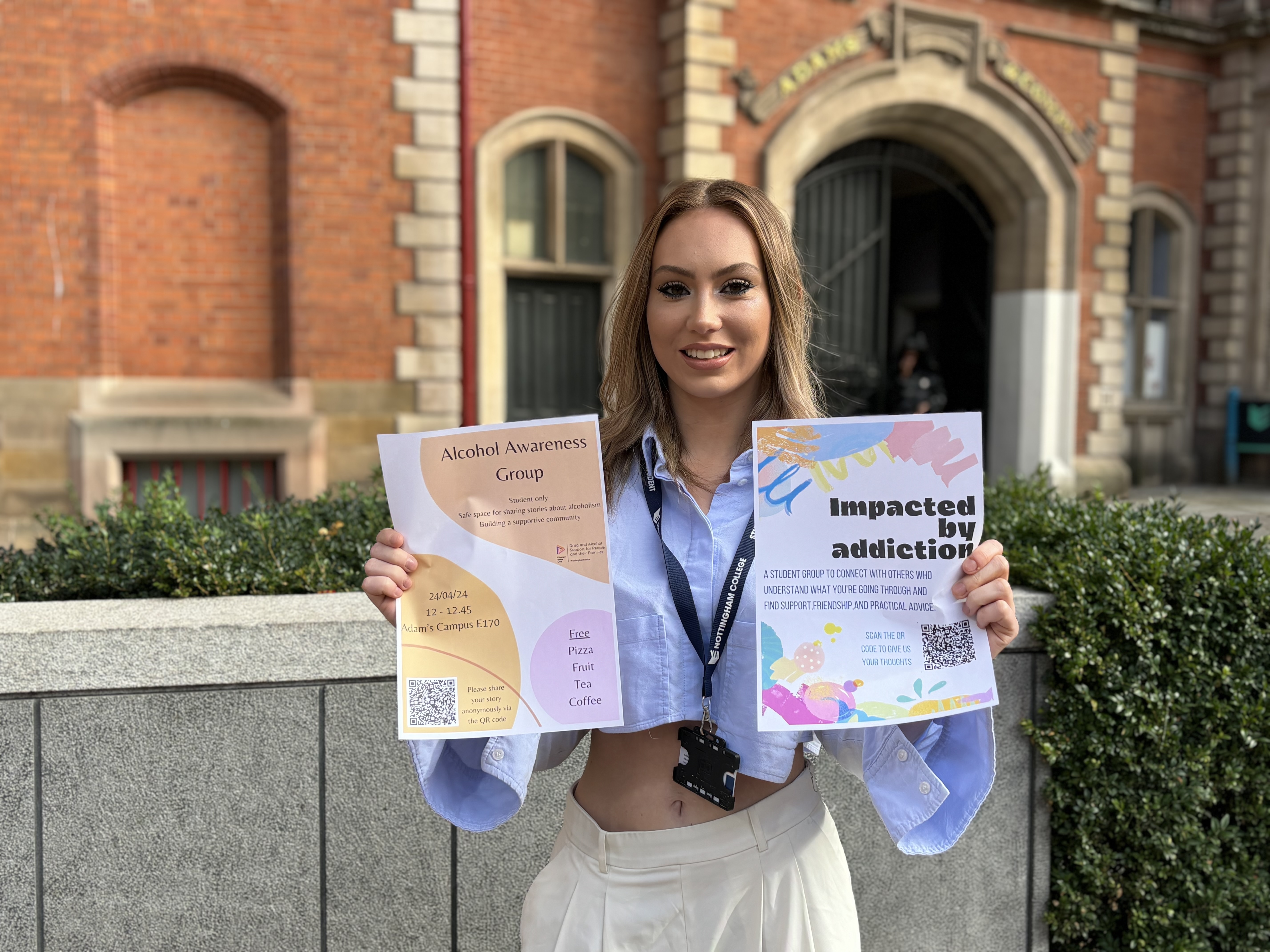 Antonia holding posters outside the Adams Building