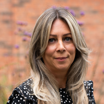 A member of staff smiling