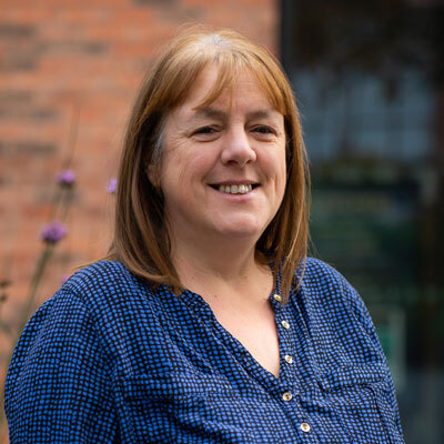 A member of staff smiling