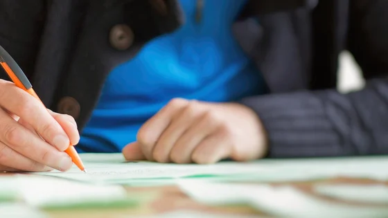 A student sitting at a desk writing