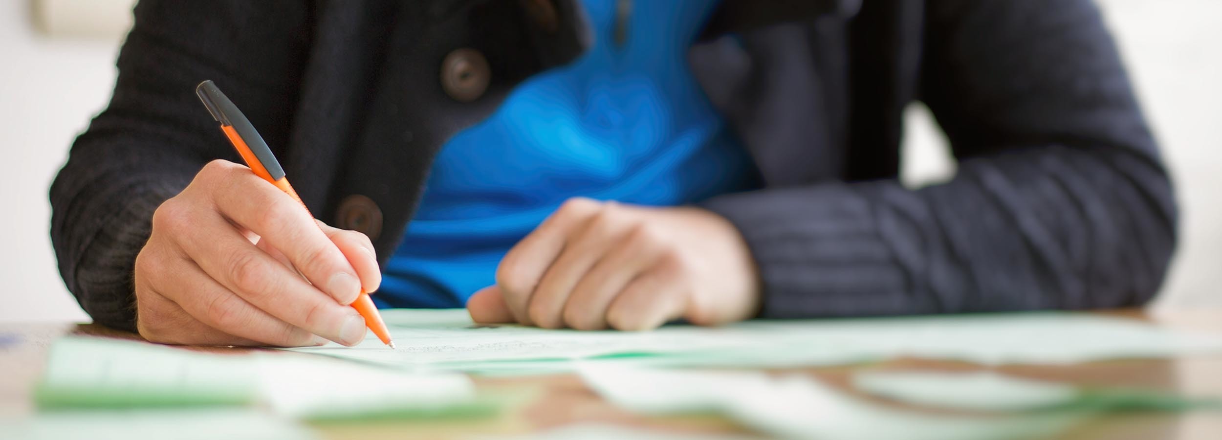 A student sitting at a desk writing