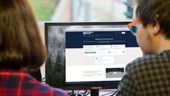 Two students looking at an image.