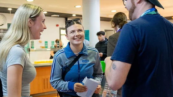 Students chatting and smiling at one of our campuses