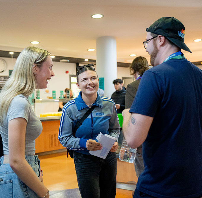 Students chatting and smiling at one of our campuses
