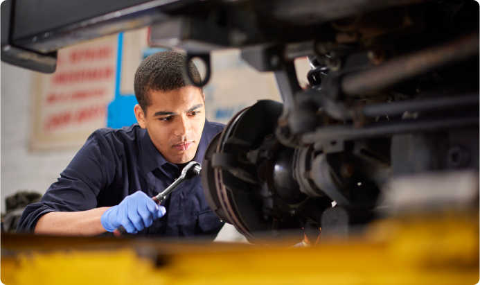 A student working on a car in a workshop