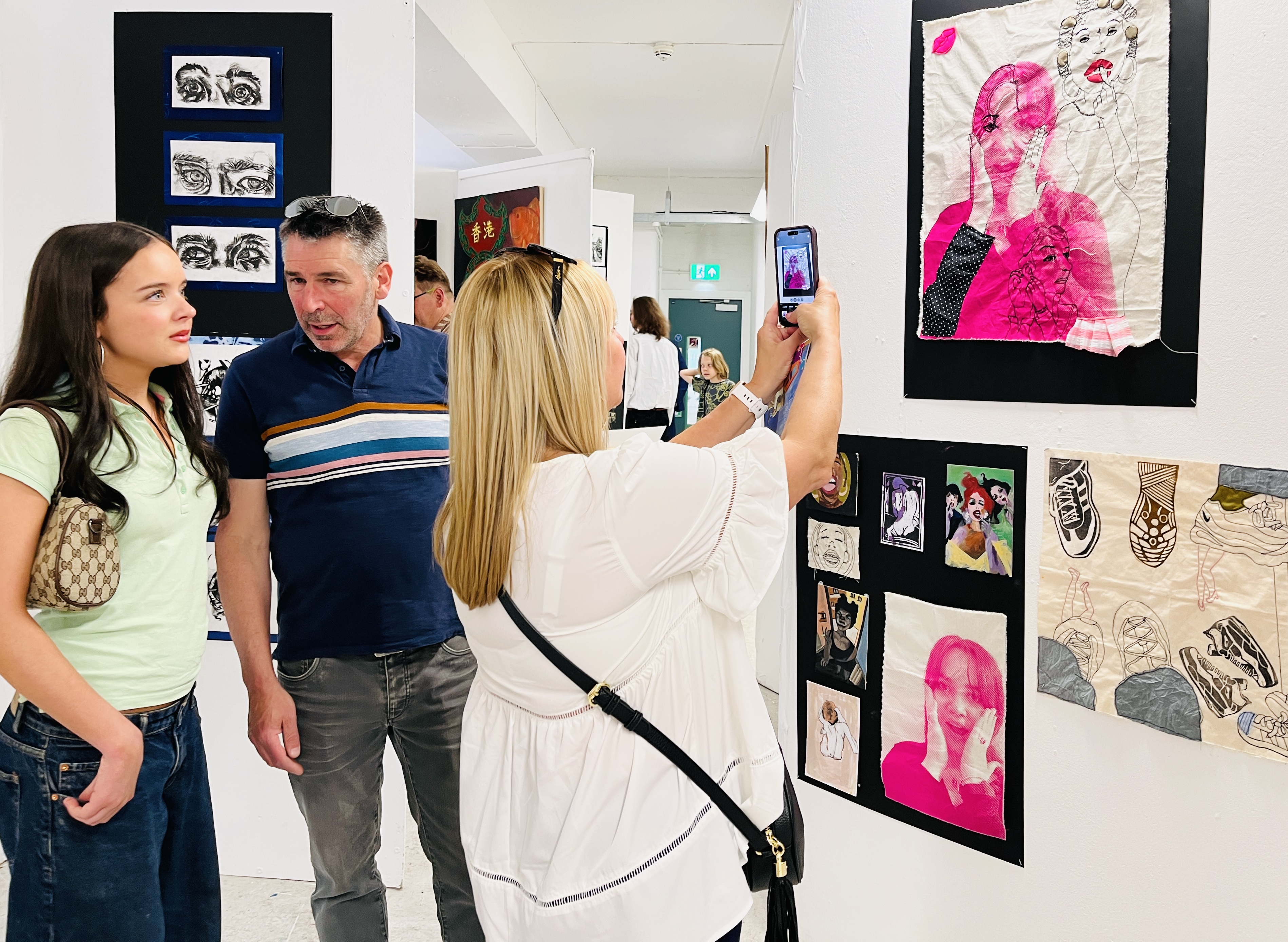 A student and her parents looking around the art exhibitions