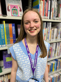 A photograph of Freya Sweeney in the library at High Pavement