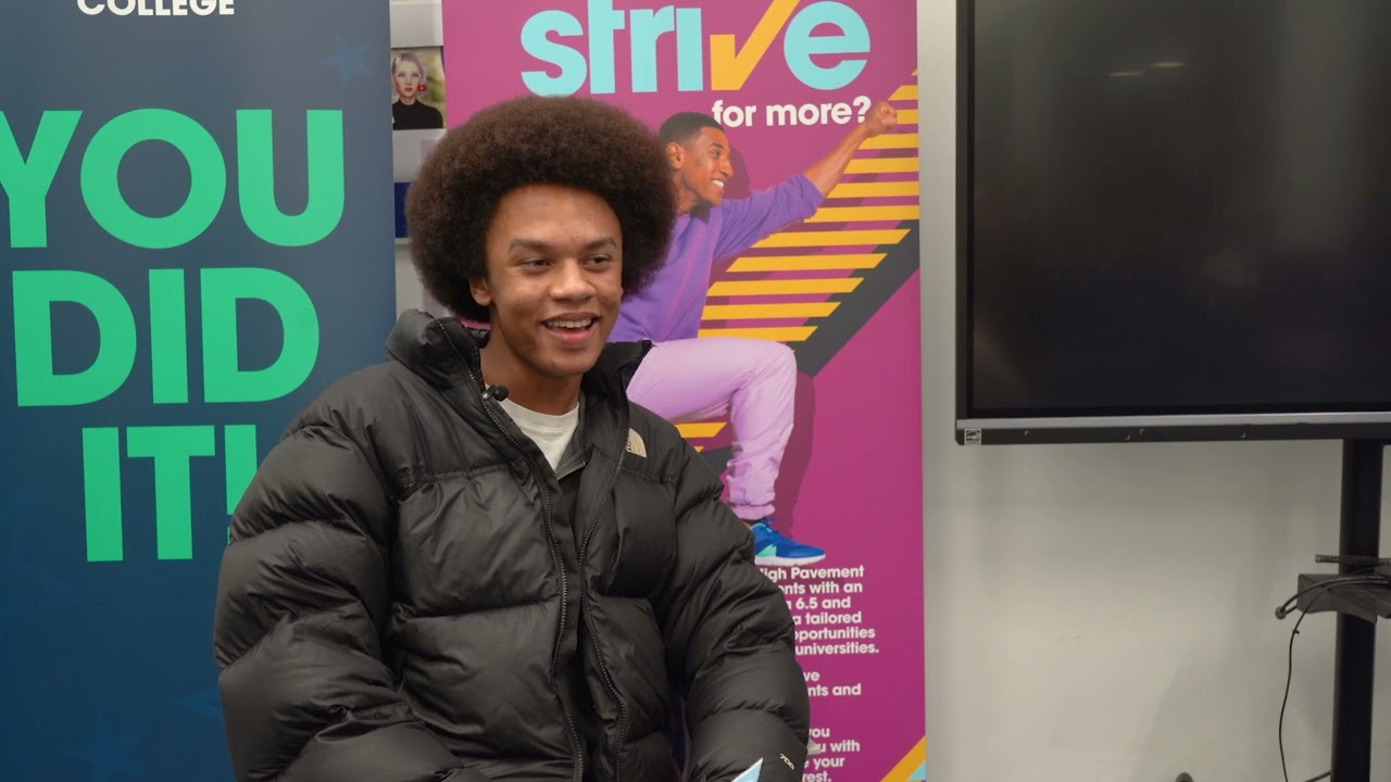 A thumbnail from the video showing a student sitting in front of Nottingham College banners.