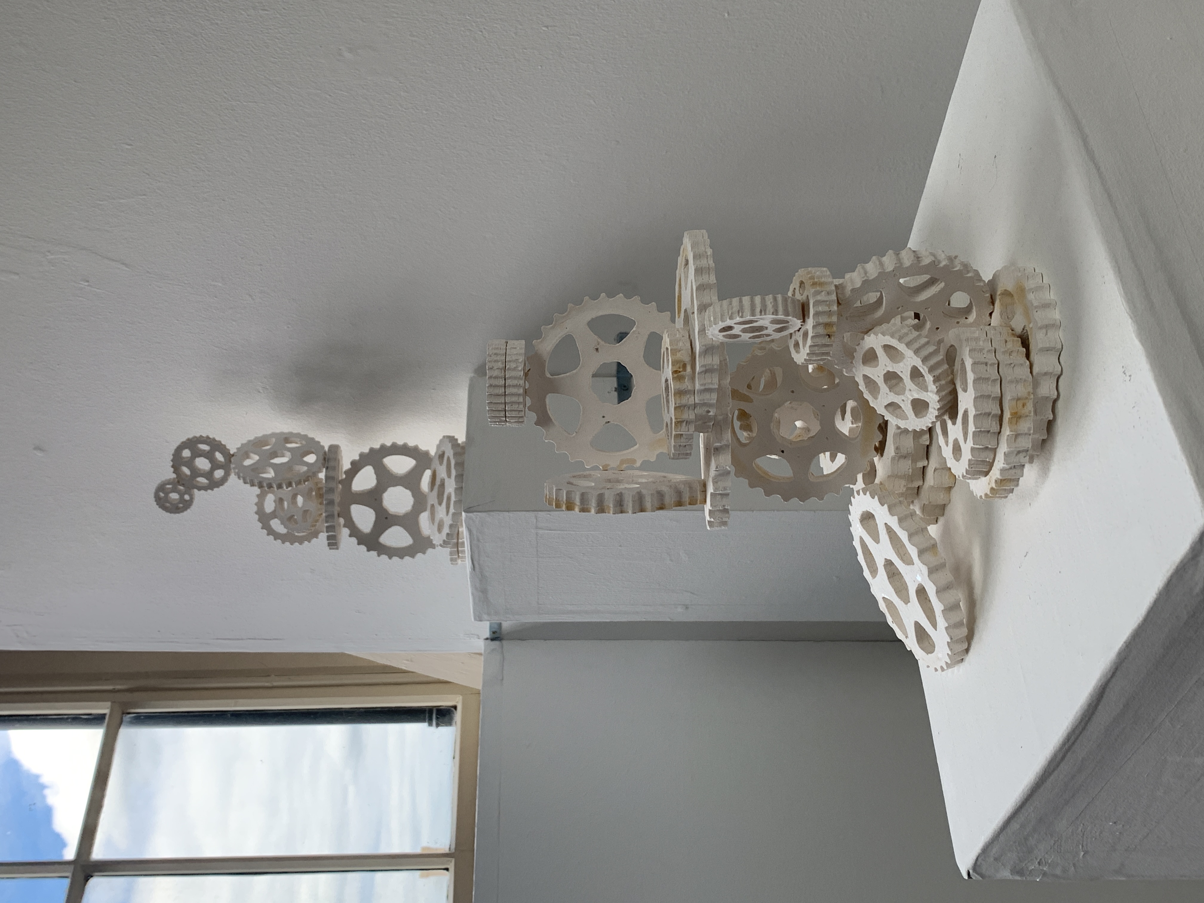 Sculptural display of cogs stacked on eachother