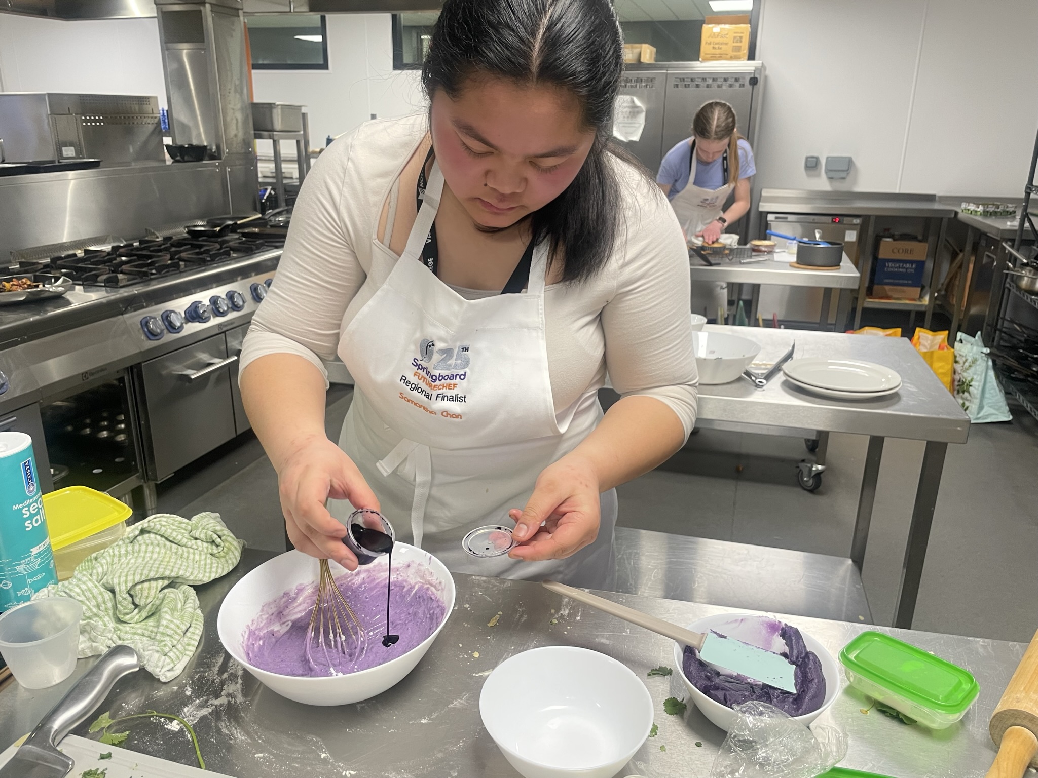 A student in a professional kitchen.