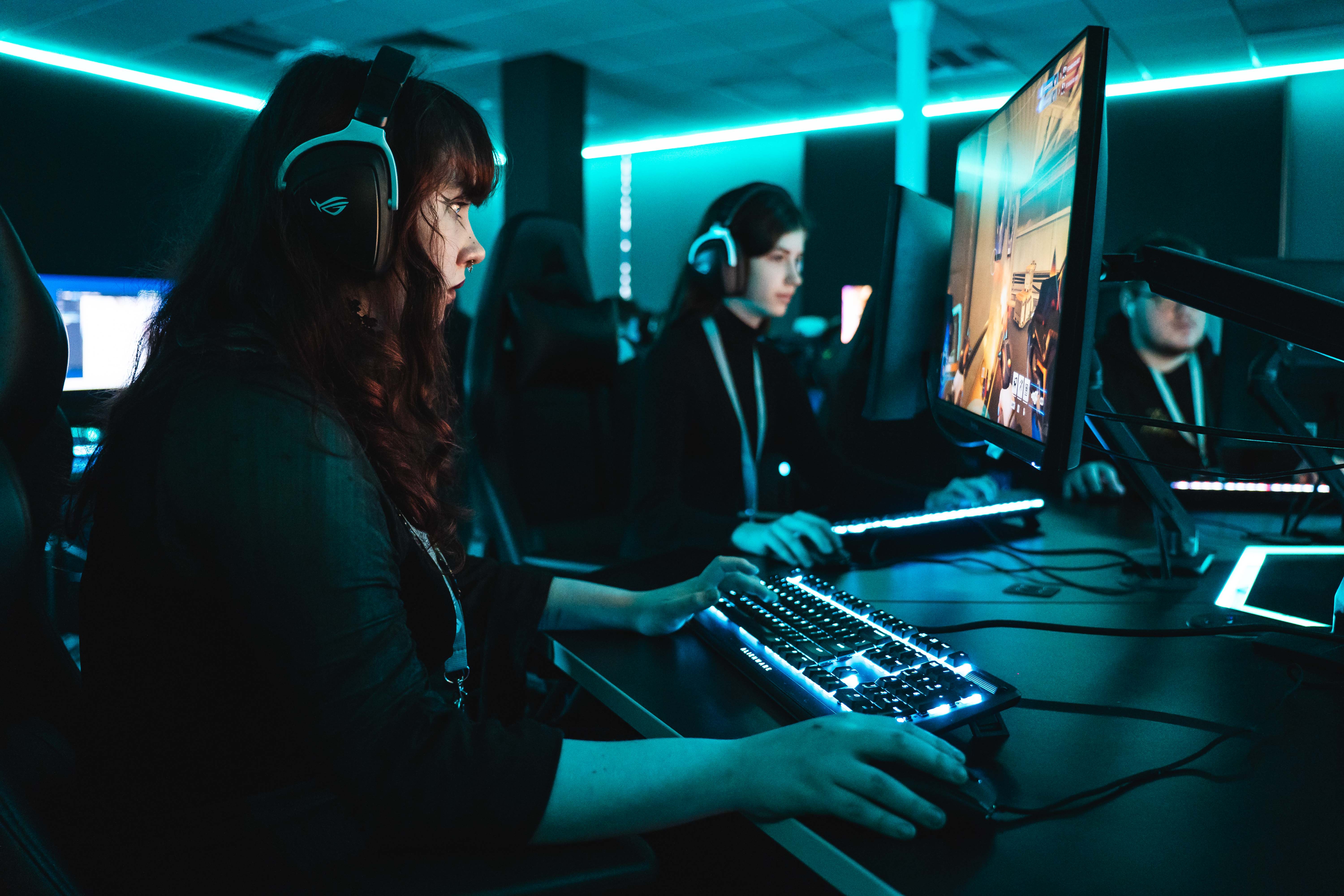 Two female students playing video games using professional equipment