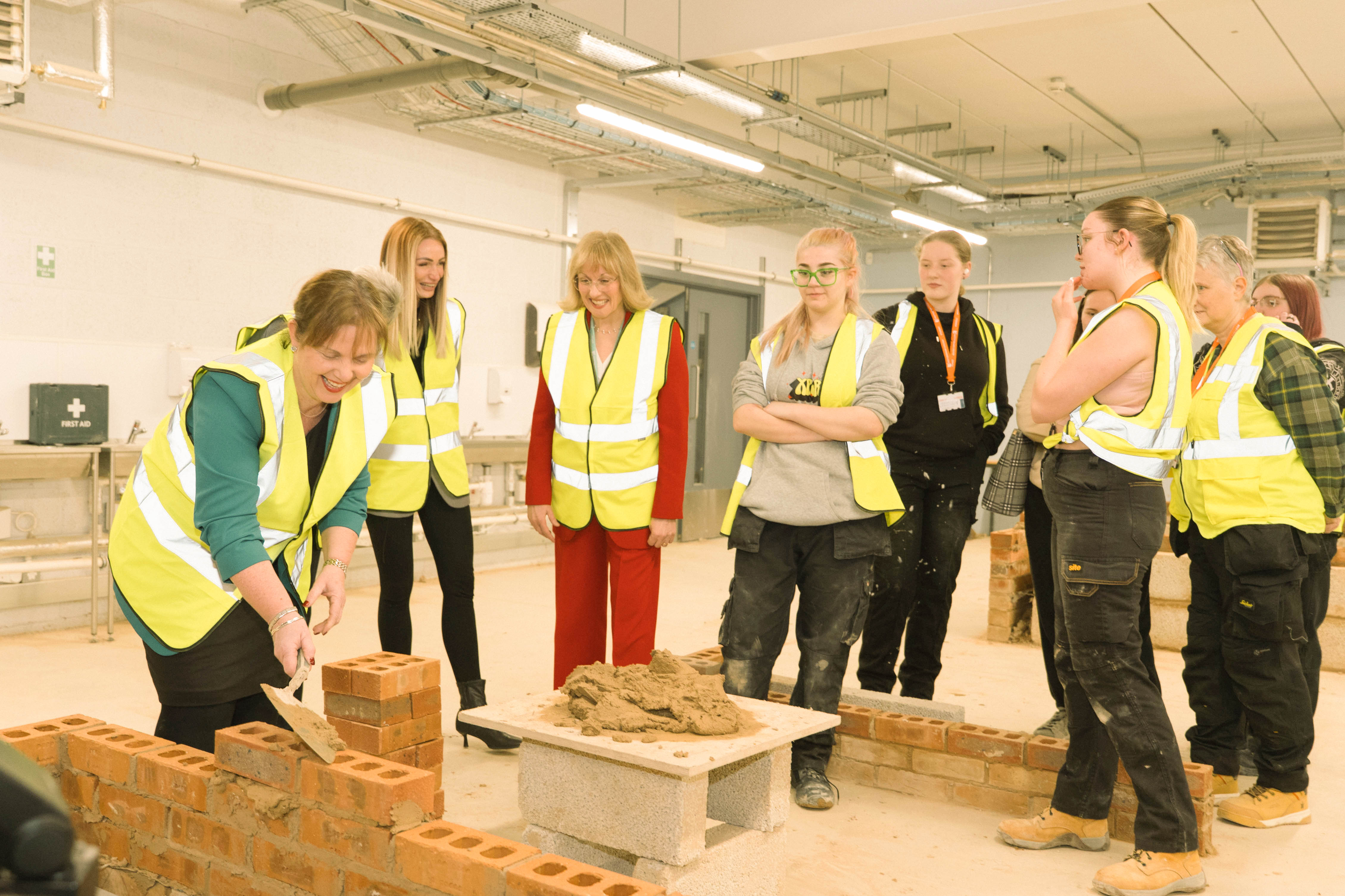 Claire Ward laying a bring with Janet Smith overseeing