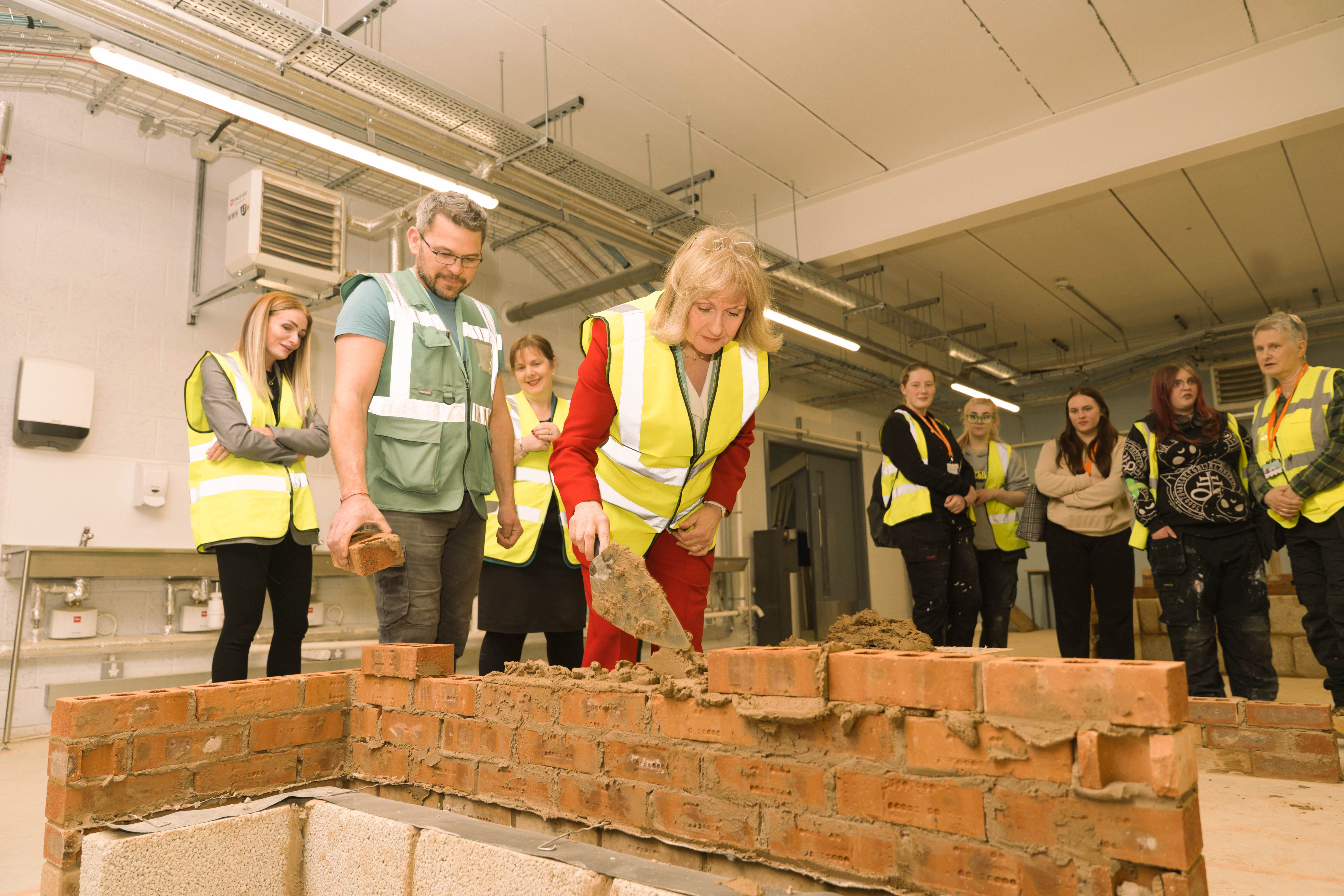 Janet Smith laying a brick