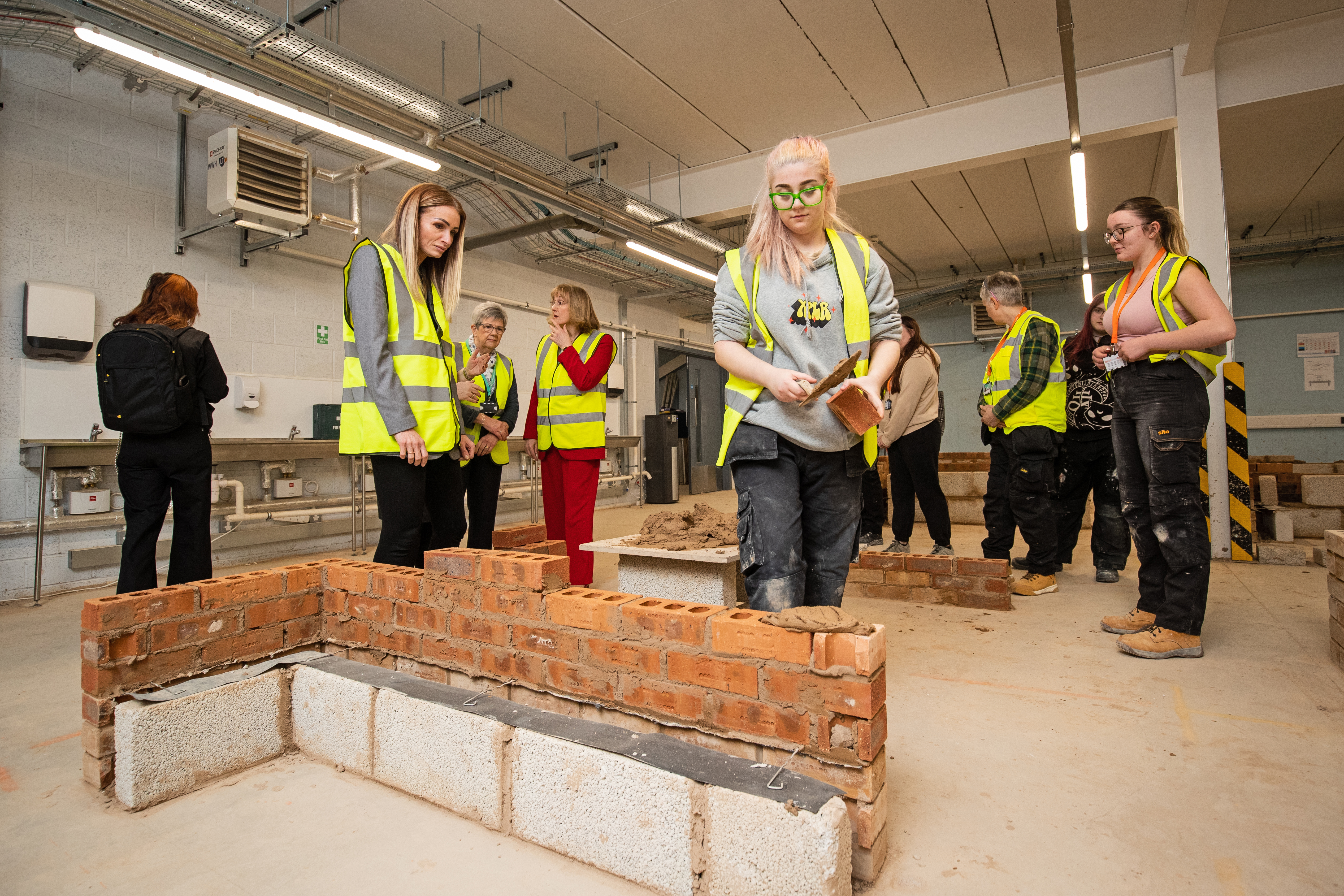 Student, Lily Smith, laying a brick