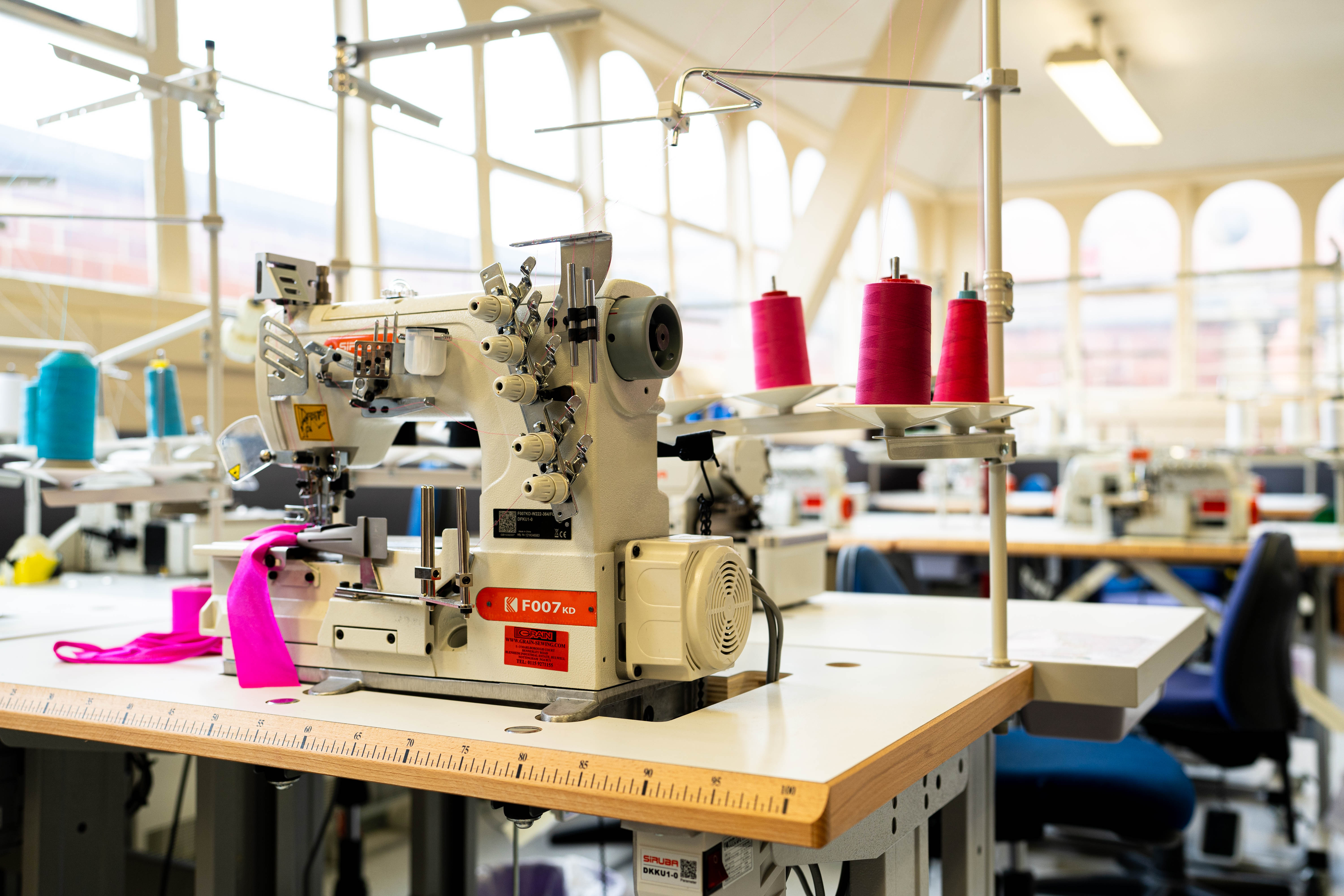 A room filled with thread, sewing machines and clothes