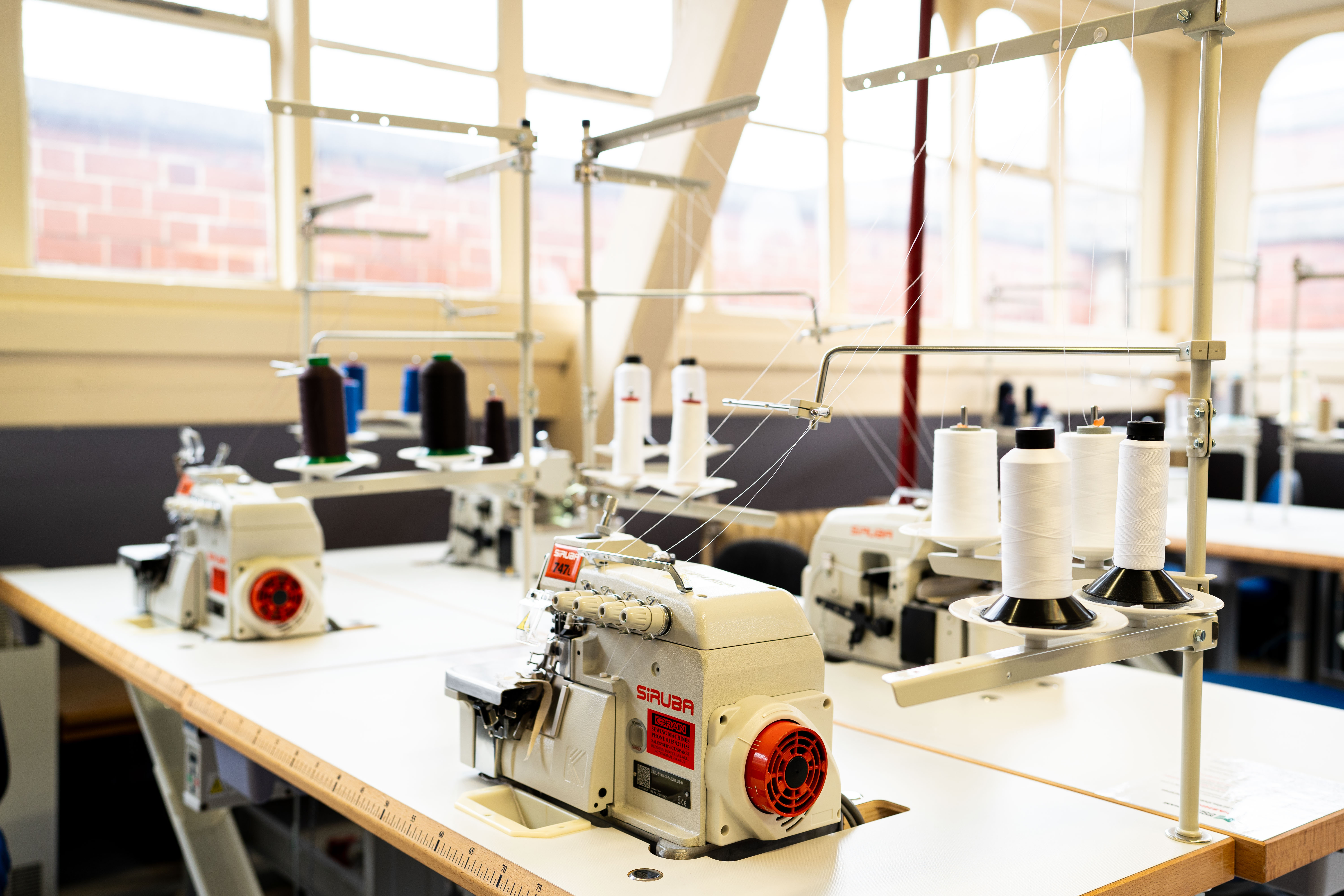 Work benches with sewing machines on